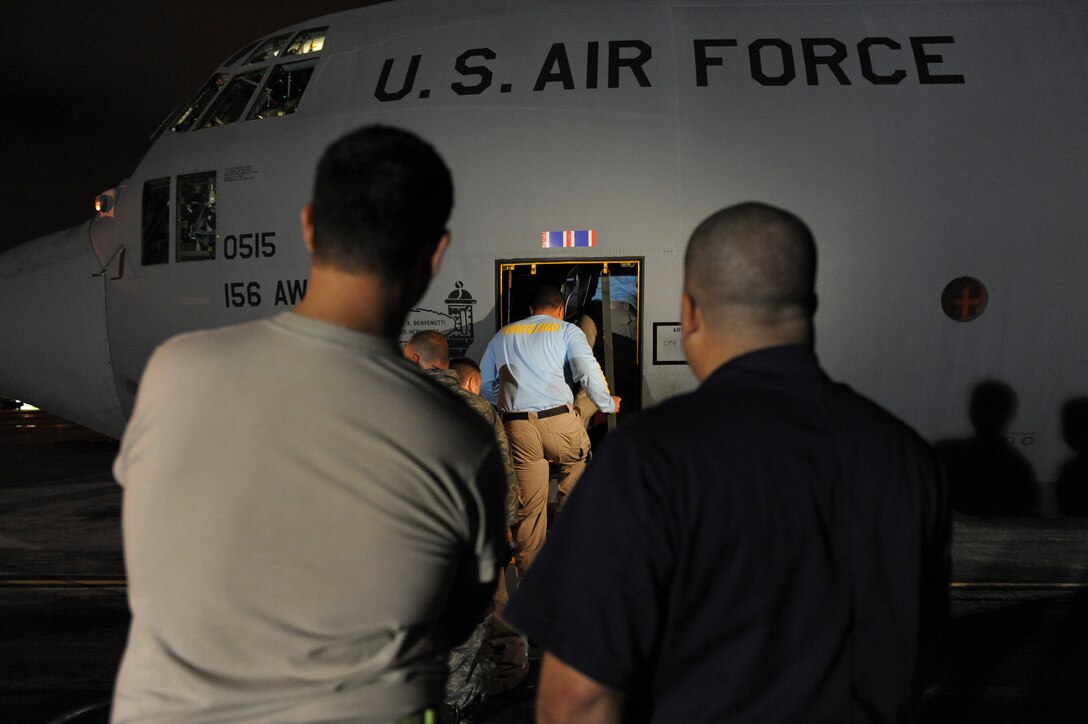 Airmen from the Puerto Rico Air National Guard’s 156th Airlift Wing escort Puerto Rican aid relief workers aboard a C-130E Hercules aircraft Jan. 16, 2010, to support the relief effort in Haiti in the aftermath of a devastating earthquake. (U.S. Air Force photo/Staff Sgt. Desiree N. Palacios)