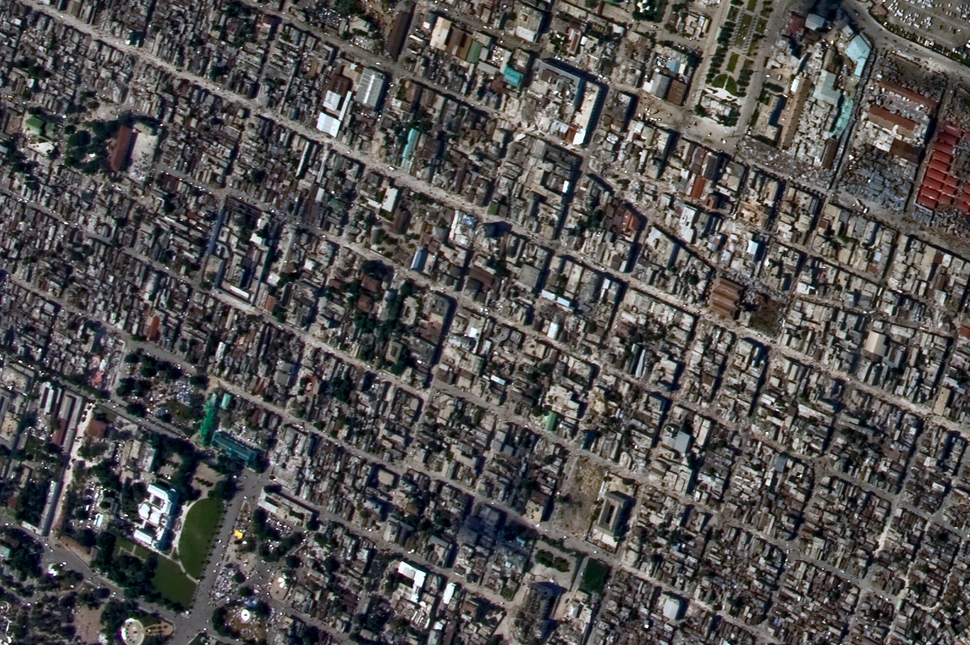 An aerial view of Port-au-Prince, Haiti with the damaged Presidential Palace in the bottom left hand corner from an OC-135B Observation Aircraft Jan. 14. The OC-135B flew over Haiti for over three hours taking panoramic photos to help coordinate U.S. military support to the Haiti relief effort. (U.S. Air Force photo by Airman 1st Class Perry Aston) (Released)