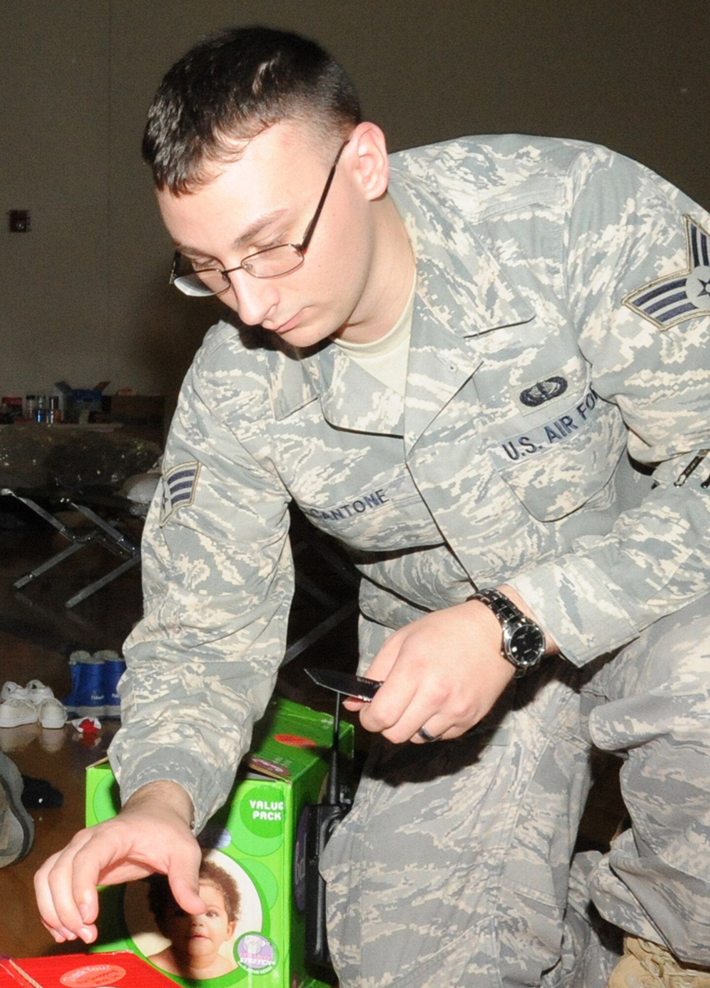 JOINT BASE MCGUIRE-DIX-LAKEHURST, N.J. – Senior Airman Ryan Cantone, 87th Force Support Squadron reservationist, hands out diapers to evacuees with babies at the McGuire Fitness Center Saturday. About 500 evacuees have arrived to the center since early Friday morning, many of them with small children. (U.S. Air Force photo/Staff Sgt. Danielle Johnson)