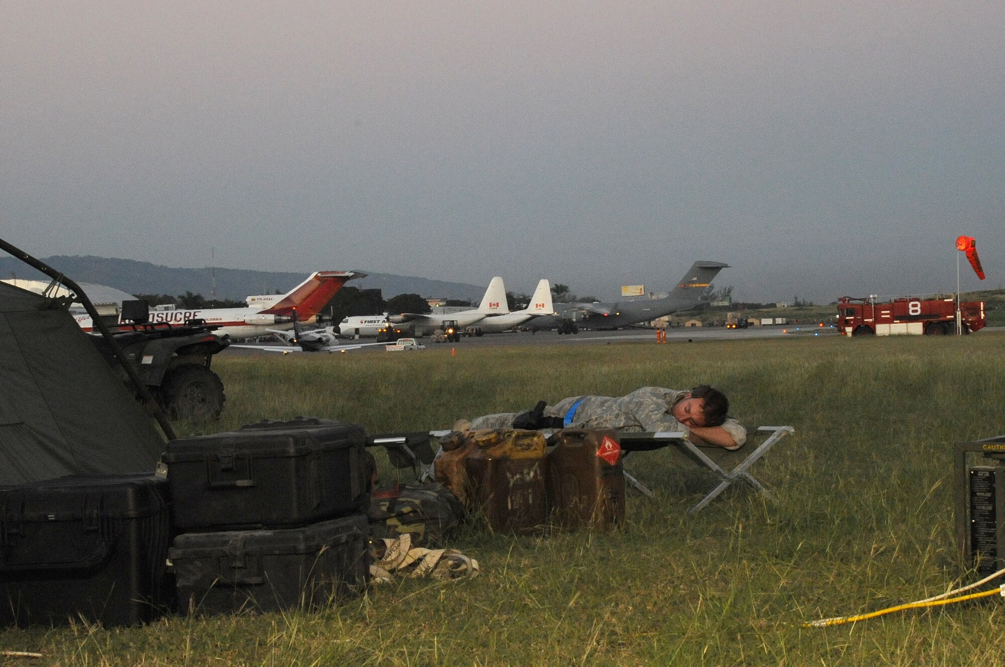 PORT AU PRINCE, Haiti -- An Airman of the 621st Contingency Response Wing takes advantage of an early-morning lull in activity at the Port au Prince airport after working through the night. The unit arrived in Haiti Thursday to organize the airfield and set up a processing area for supplies flown in to the airport, which will then be sent to an Army distribution area. (U.S. Air Force photo/Staff Sgt. Danielle Johnson)