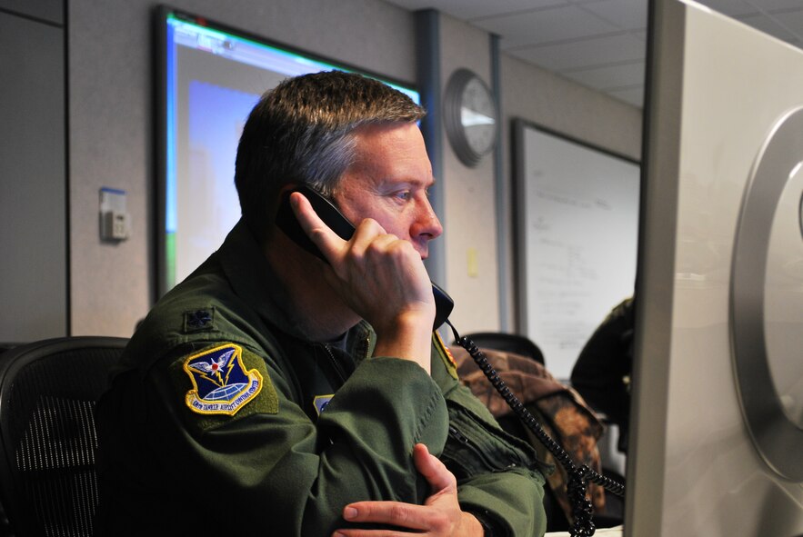 Lt. Col. Thomas Ohland, assigned to the 618th Tanker Airlift Control Center at Scott Air Force Base, Ill., monitors the status of C-130 missions supporting relief efforts in Haiti, from the 618th TACC's Contingency Response Cell, Jan. 16.  618th TACC personnel have been working around-the-clock since Tuesday to support U.S. relief efforts in Haiti after a 7.0-magnitude earthquake struck the region. The 618th TACC's Contingency Response Cell, comprised of mission planners, managers and command-and-control personnel, is specifically dedicated to Air Mobility Command's involvement in Haiti relief operations, enabling other 618th TACC personnel to continue planning missions to support other U.S. operations worldwide, including in support of Operations Iraqi and Enduring Freedom. (U.S. Air Force photo/Capt. Justin Brockhoff) 
