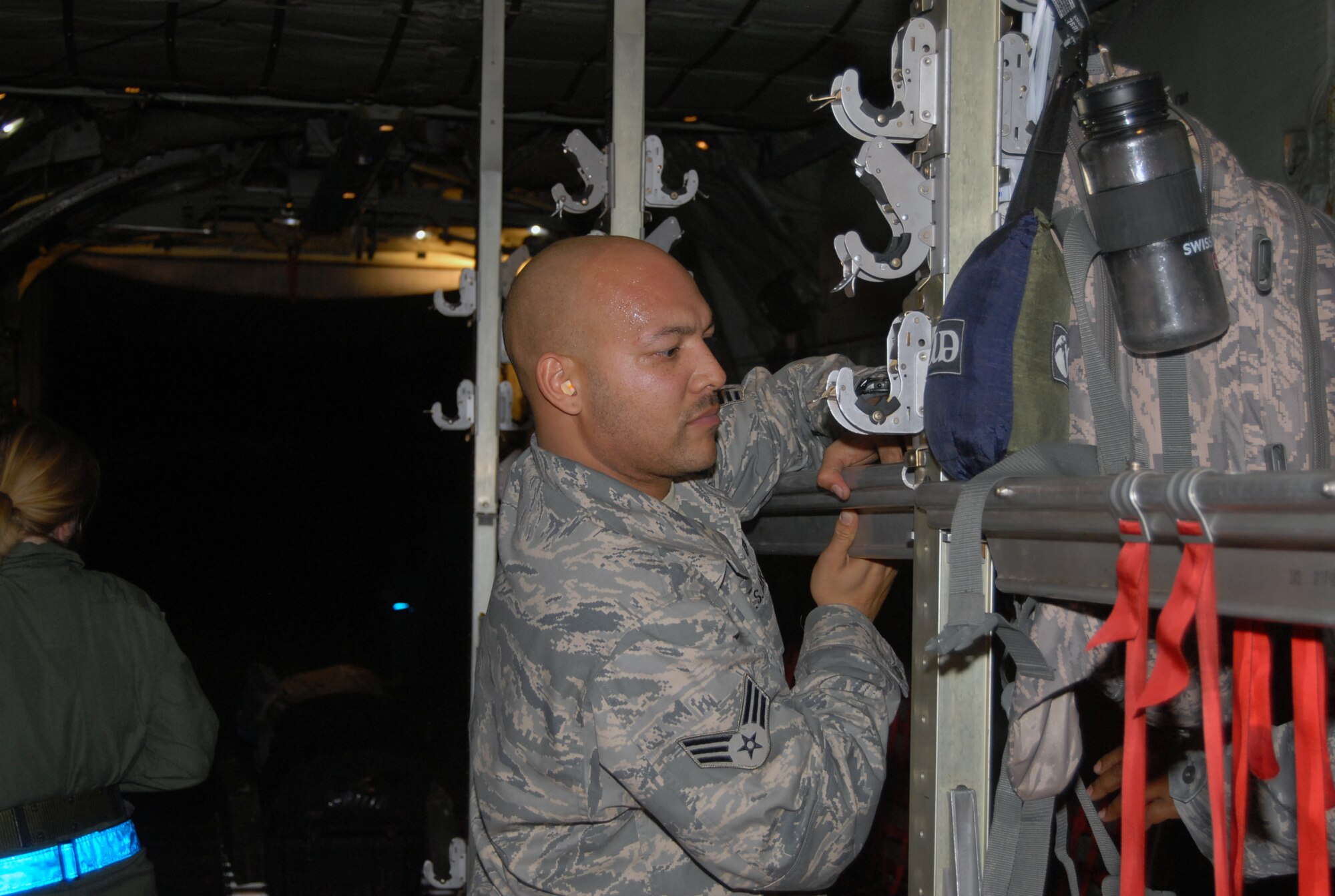 Senior Airman James Neely, crew chief assigned to the 2nd Airlift Squadron, secures seats on a C-130 aircraft in Port-au-Prince, Haiti Jan. 15. The aircraft, assigned to the 440th Airlift Wing, traveled to Port-au-Prince in support of Humanitarian relief efforts after a 7.0-magnitude earthquake struck the Caribbean nation Jan 12. (U.S. Air Force photo/Vicki Johnson)