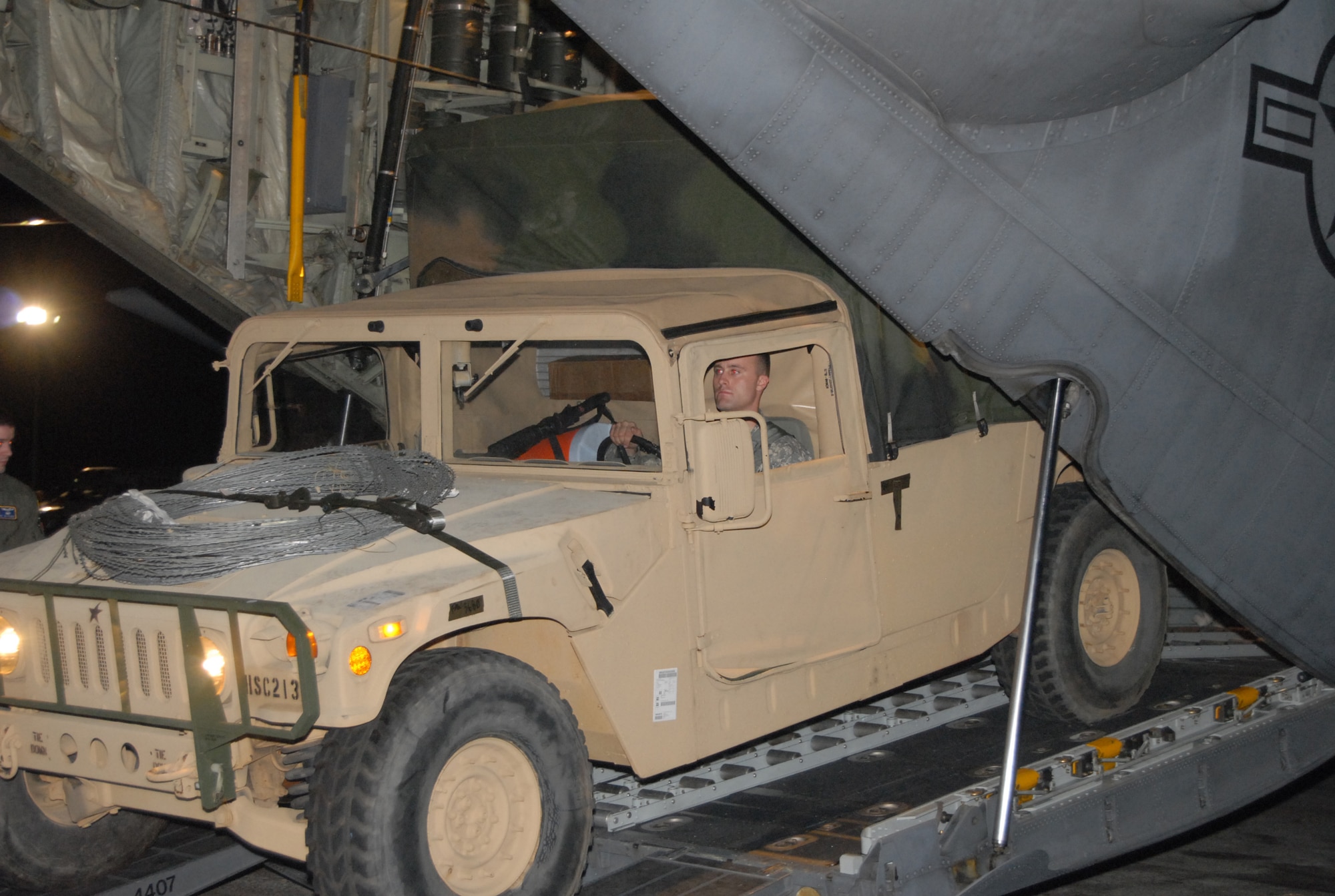 A soldier off loads a HMMWV from a 440th Airlift Wing C-130 aircraft  at the Port-au-Prince airport, Haiti on Jan.15 in support of humanitarian relief efforts after a 7.0-magnitude earthquake devastated the Caribbean nation Jan 12. (U.S. Air Force photo/Vicki Johnson)