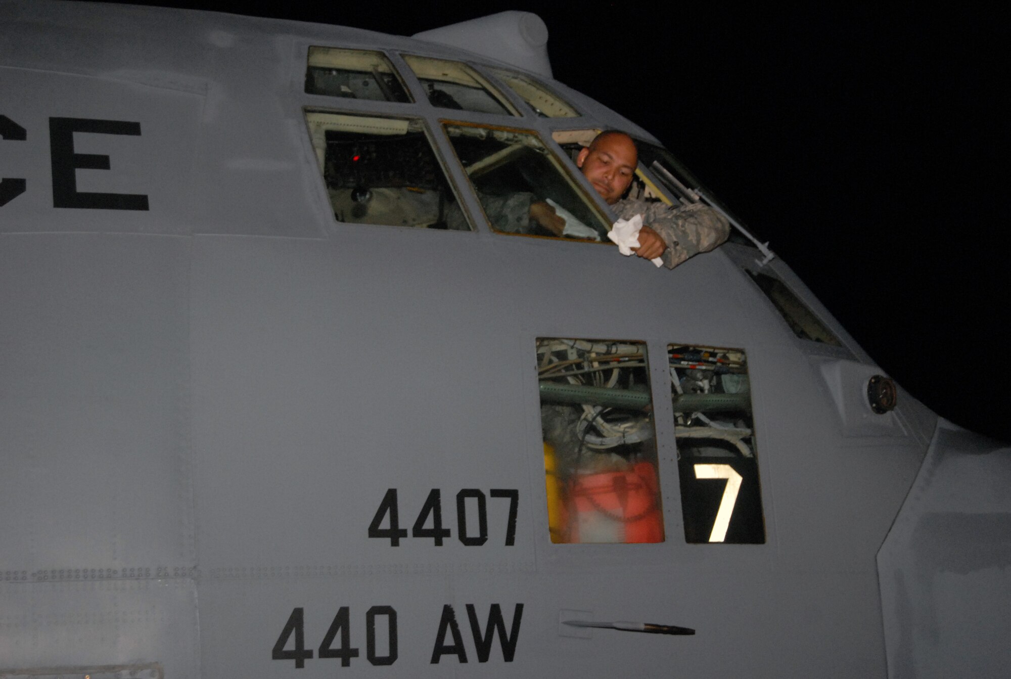 Senior Airman James Neely, crew chief assigned to the 2nd Airlift Squadron, cleans the windshield on a C-130 aircraft in Port-au-Prince, Haiti Jan. 15. The aircraft, assigned to the 440th Airlift Wing, traveled to Port-au-Prince in support of Humanitarian relief efforts after a 7.0-magnitude earthquake struck the island nation Jan 12. (U.S. Air Force photo/Vicki Johnson)