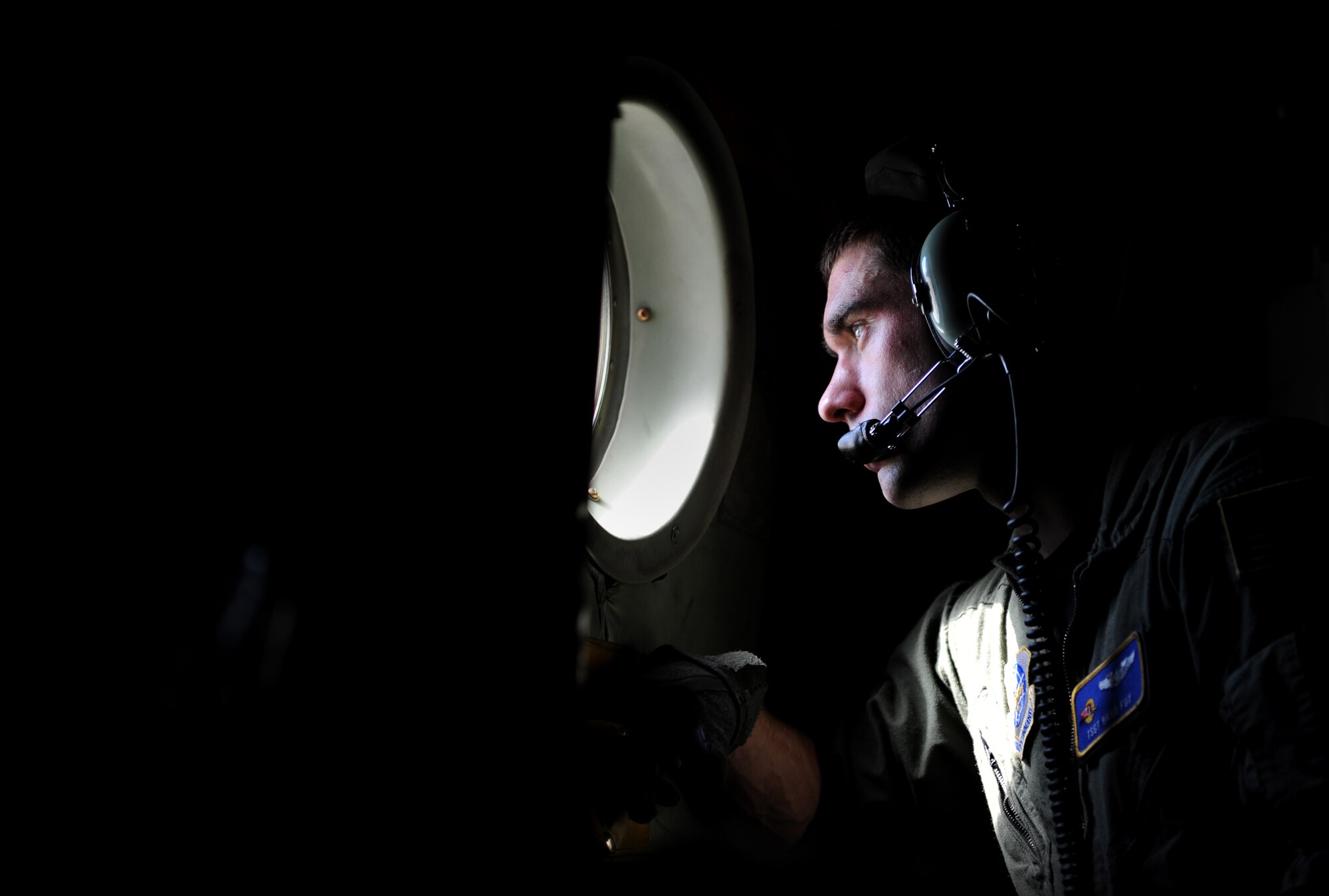 100115-F-2034C-174Staff Sgt. Brad Fox scans for hazards as his C-130 Hercules taxis from its parking spot Jan. 15, 2010 prior to leaving Port-au-Prince, Haiti. Sgt. Fox is a loadmaster from 2nd Airlift Squadron, Pope Air Force Base, Fayetteville, North Carolina. U.S. Southern Command is deploying assets to Haiti to conduct search and rescue operations, damage assessments, and transitions sustained Humanitarian Assistance/Disaster Relief operations in order to prevent human suffering and additional loss of life. (U.S. Air Force photo/Master Sgt. Shane A. Cuomo) 
