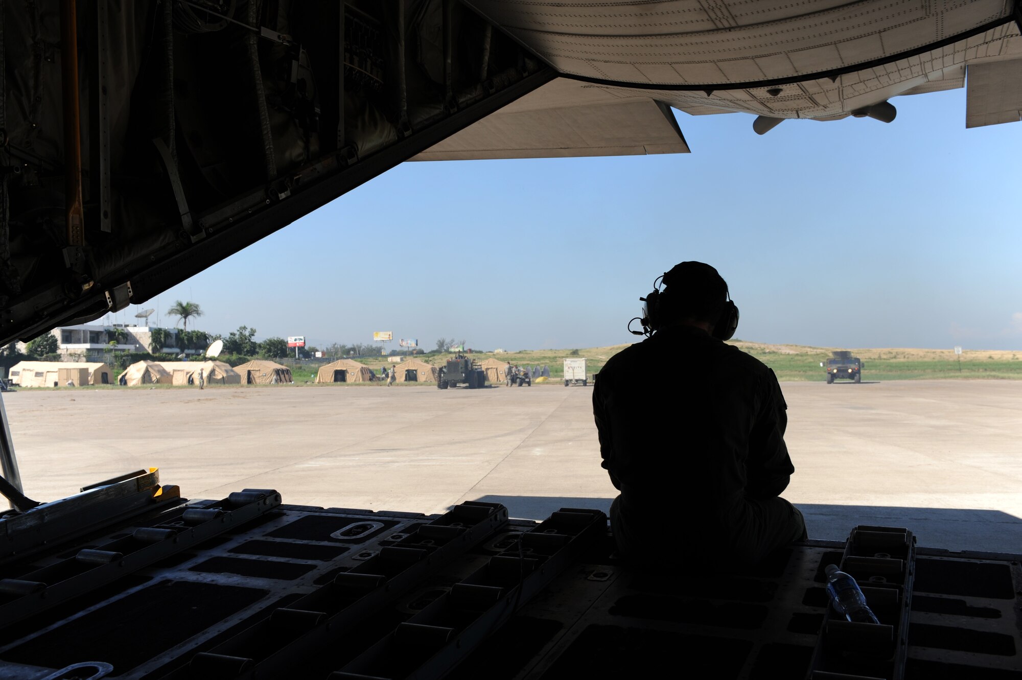 100115-F-2034C-158Staff Sgt. Brad Fox backs his C-130 Hercules from its parking spot Jan. 15, 2010 prior to leaving Port-au-Prince, Haiti. Sgt. Fox is a loadmaster from 2nd Airlift Squadron, Pope Air Force Base, Fayetteville, North Carolina. U.S. Southern Command is deploying assets to Haiti to conduct search and rescue operations, damage assessments, and transitions sustained Humanitarian Assistance/Disaster Relief operations in order to prevent human suffering and additional loss of life. (U.S. Air Force photo/Master Sgt. Shane A. Cuomo) 