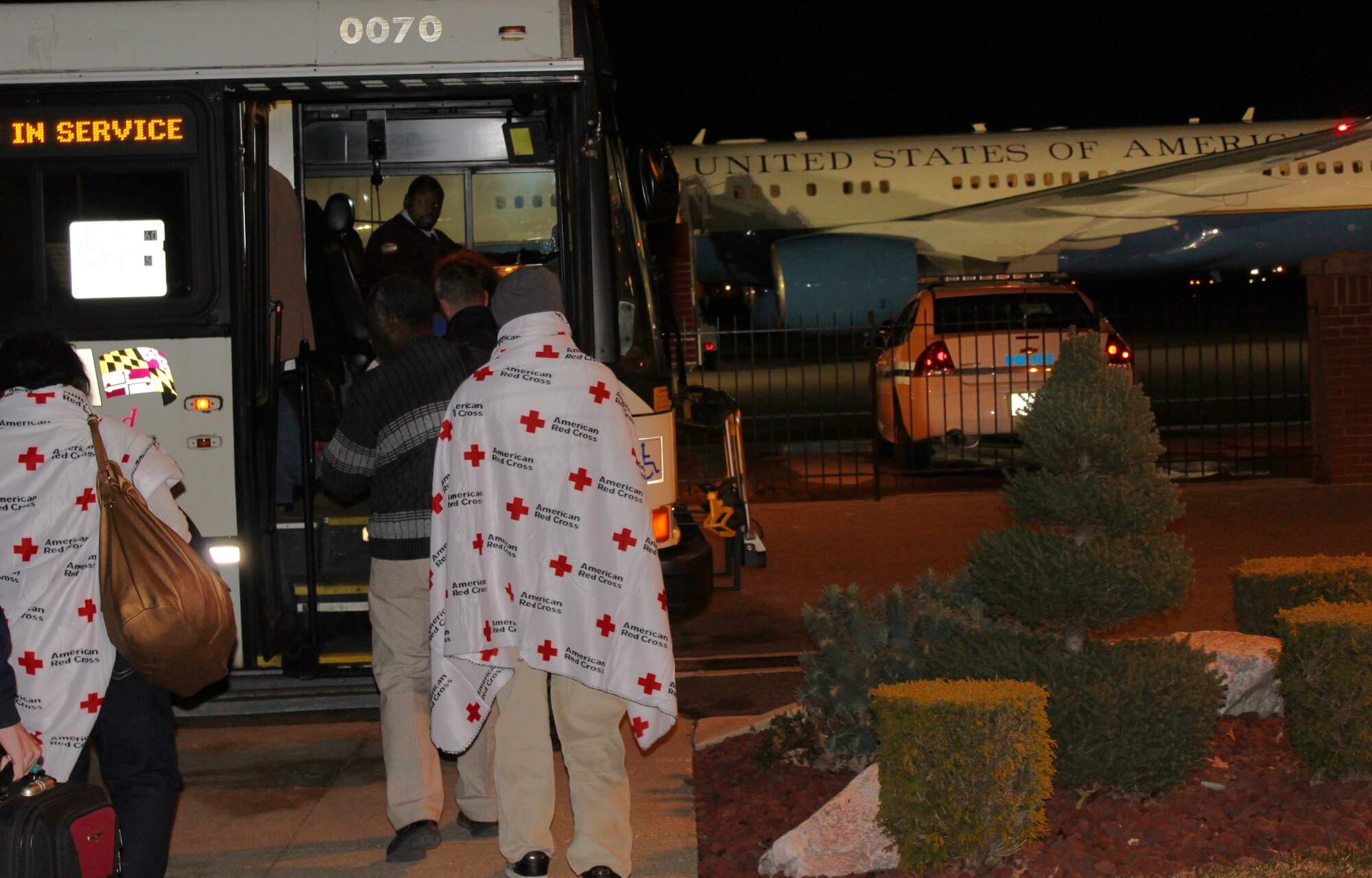 After arriving at Joint Base Andrews on an 89th Airlift Wing C-32, 22 survivors of the 7.0-magnitude earthquake that hit Haiti Jan. 12 board a bus headed for a nearby hotel Jan.17, 2010. The survivors were met upon arrival here by a medical team consisting of 79th Medical Wing personnel, Prince George's County emergency technicians and Red Cross workers who ensured the passengers were in good health. (U.S. Air Force photo by Master Sgt. J.C. Woodring)