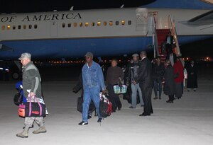 Colonel John Long, 316th Mission Support Group commander, left, helps repatriated U.S. citizens with their luggage as they disembark from an 89th Airlift Wing C-32 Jan. 17, 2010. Secretary of State Hillary Clinton traveled to Joint Base Andrews with 22 survivors of the 7.0-magnitude earthquake that hit Haiti Jan. 12. In Haiti, the secretary met with Haitian President Rene Preval and pledged U.S. aid in the country’s relief effort. The survivors were met upon arrival here by a medical team consisting of 79th Medical Wing personnel, Prince Georges County emergency technicians and Red Cross workers who ensured the passengers were in good health. (U.S. Air Force photo by Master Sgt. J.C. Woodring)