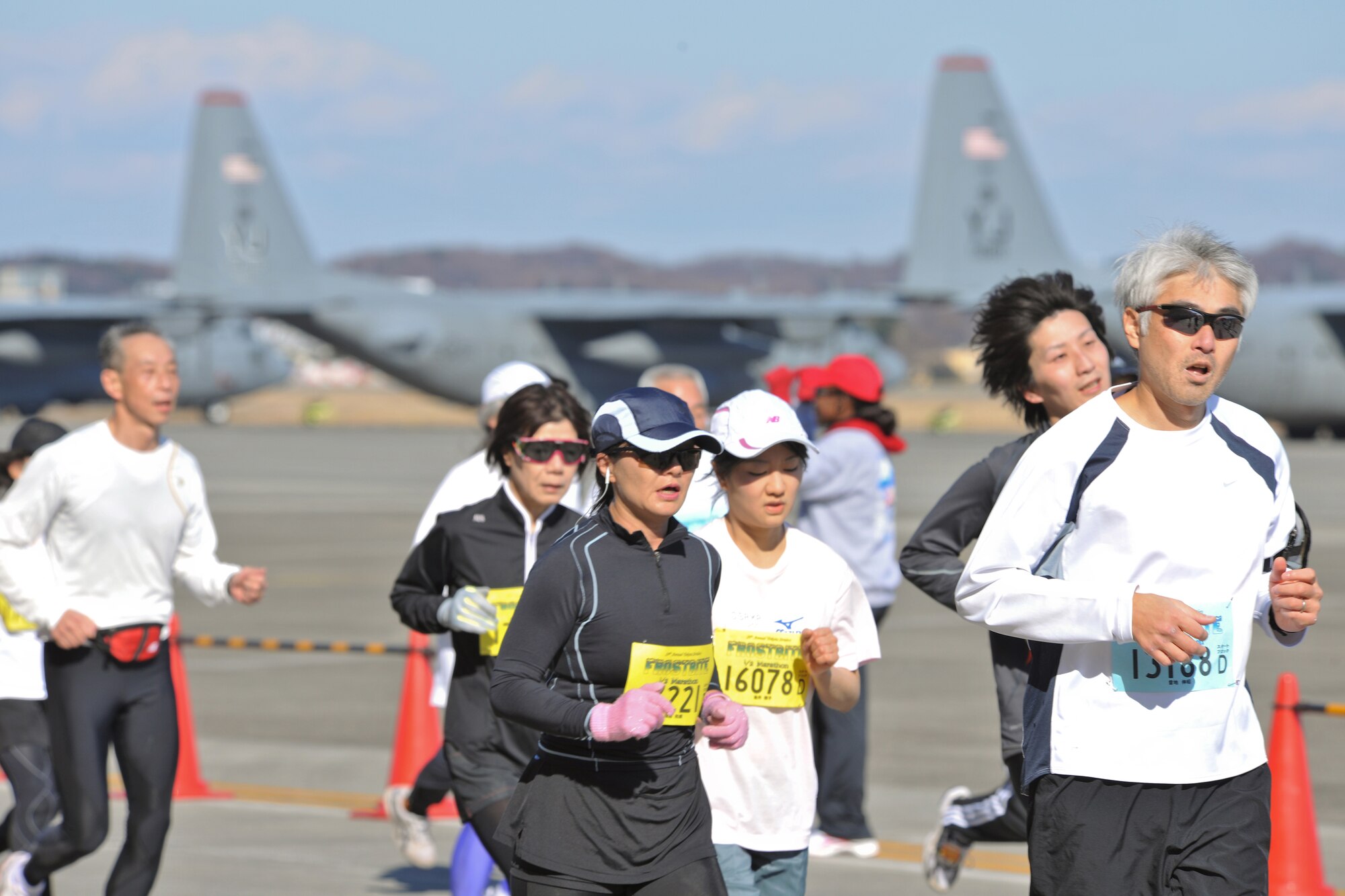 YOKOTA AIR BASE, Japan --  Japanese runners enjoy running by the flight line during the 29th Annual Frostbite Road Race, Jan. 17. Yokota Air Base's flightline provides a unique running location, which is very rare in Japan. (U.S. Air Force photo/Osakabe Yasuo)