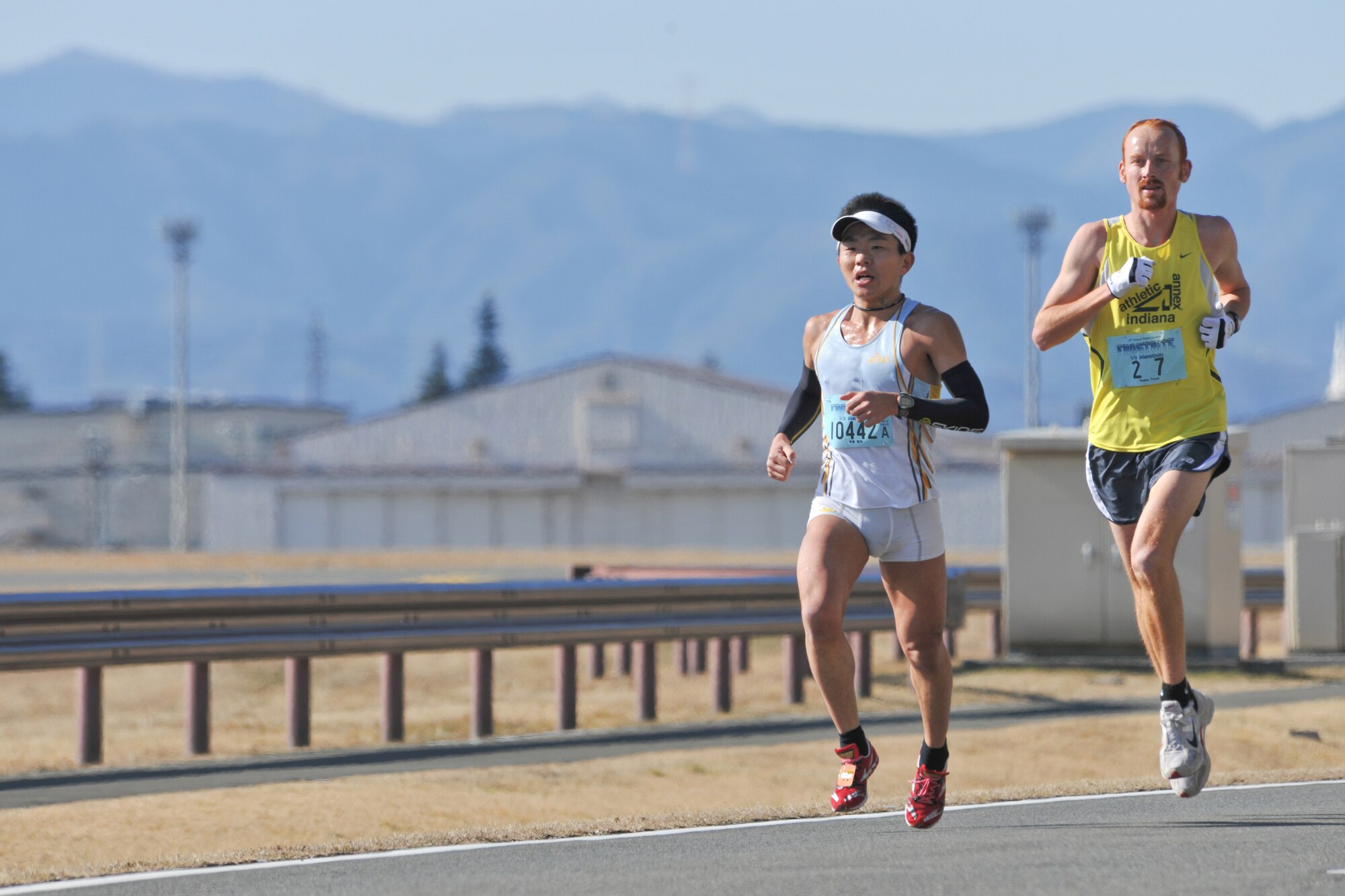 YOKOTA AIR BASE, Japan -- Yokota Striders Running Club sponsored the 29th Annual Frostbite Race here, Jan. 17.  Yokota Air Base provided 9,000 participants with a unique running location. Thomas Frazer (Right) and Kenichi Hirasawa (Left) run a dead heat. Frazer got second place with a time of 1:10:06. (U.S. Air Force photo/Osakabe Yasuo)
