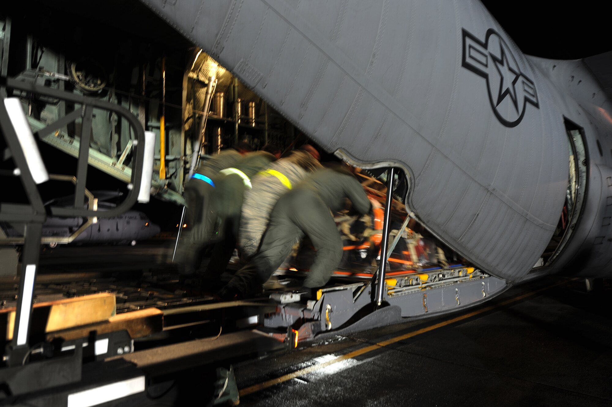 Airmen from the Puerto Rico Air National  Guard's 156th Airlift Wing load one of the unit's C-130E Hercules aircraft with search and rescue equipment that was bound for Haiti along with a team of Puerto Rican search and rescue workers Jan. 16 at Munoz Air National Guard Base, P.R. In the first week after the earthquake devastated the island nation of Haiti, the 156 AW transported more than 117 tons of cargo and 294 passengers and evacuated 70 United States citizens. (U.S. Air Force photo/Staff Sgt. J. Paul Croxon)