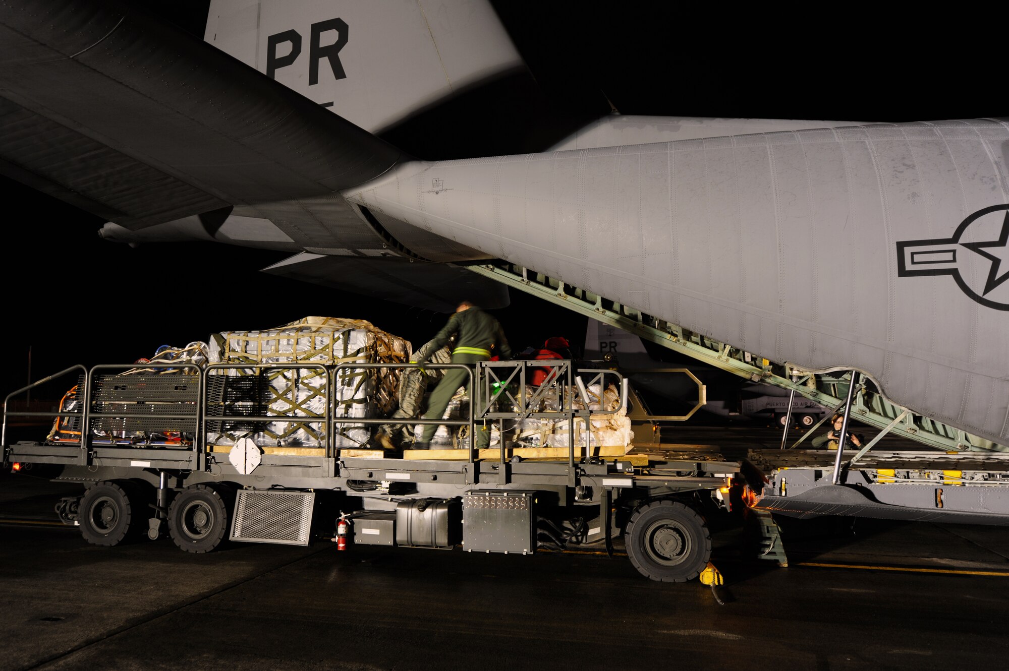 Airmen from the Puerto Rico Air National  Guard's 156th Airlift Wing load one of the unit's C-130E Hercules aircraft with search and rescue equipment that was bound for Haiti along with a team of Puerto Rican search and rescue workers Jan. 16 at Munoz Air National Guard Base, P.R. In the first week after the earthquake devastated the island nation of Haiti, the 156 AW transported more than 117 tons of cargo and 294 passengers and evacuated 70 United States citizens. (U.S. Air Force photo/Staff Sgt. J. Paul Croxon)