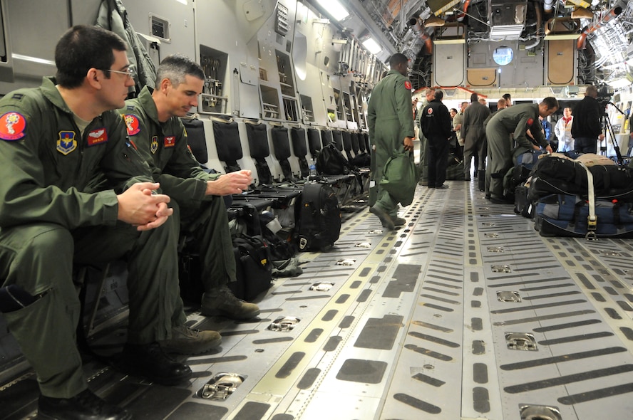 ALTUS AIR FORCE BASE, Okla-- Captains Jeremy Williams and Dan Blum, C-17 instructor pilots from the 58th Airlift Squadron, await take off with other aircrew members aboard the C-17 Globemaster III, Jan.18. The crews flew to Pope Air Force Base, N.C., to take part in Operation Unified Response. There they will be sectionalized onto different flights in order to participate in the humanitarian relief effort in Haiti. (U.S. Air Force photo / Senior Airman Cherice Bryant)
