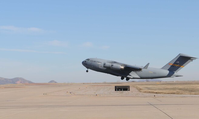ALTUS AIR FORCE BASE, Okla. -- An Altus C-17 Globemaster III lifts off with four crews on board to take part in the humanitarian relief effort, Operation Unified Response Jan. 18. Altus sent six Globemaster IIIs to assist with the relief effort in Haiti by delivering supplies such as food and water. Altus aircrews will be staged out of Pope AFB, N.C. (U.S. Air Force photo/Senior Airman Leandra D. Hernandez)