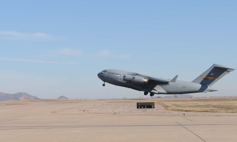 ALTUS AIR FORCE BASE, Okla. -- An Altus C-17 Globemaster III lifts off with four crews on board to take part in the humanitarian relief effort, Operation Unified Response Jan. 18. Altus sent six Globemaster IIIs to assist with the relief effort in Haiti by delivering supplies such as food and water. Altus aircrews will be staged out of Pope AFB, N.C. (U.S. Air Force photo/Senior Airman Leandra D. Hernandez)