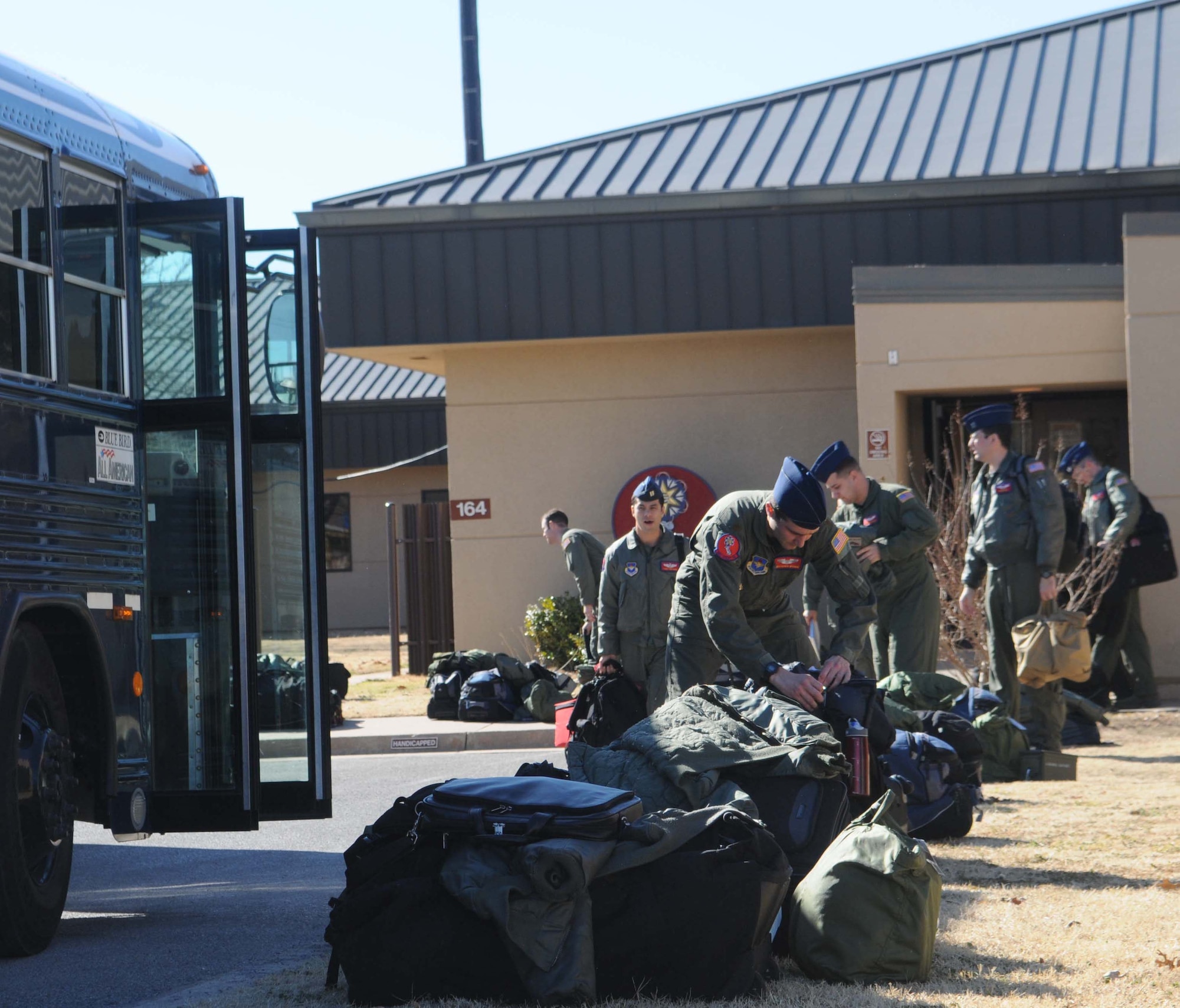 ALTUS AIR FORCE BASE, Okla. -- Members of the 58th Airlift Squadron prepare to load the buses for departure for the humanitarian relief effort, Operation Unified Response Jan. 18. Altus sent six Globemaster IIIs to assist with the relief effort in Haiti by delivering supplies such as food and water. Altus aircrews will be staged out of Pope AFB, N.C. (U.S. Air Force photo/Senior Airman Leandra D. Hernandez)