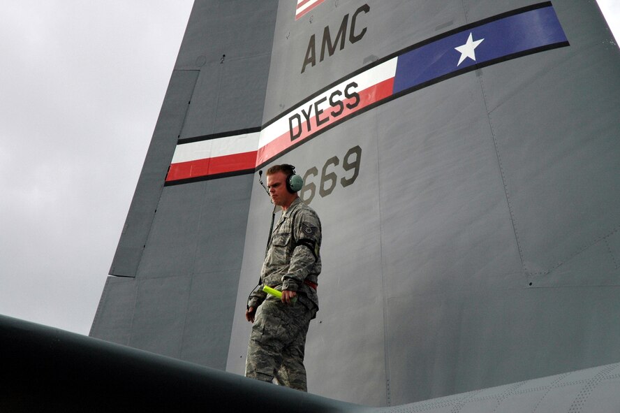 DYESS AIR FORCE BASE, Texas -- A 317th Airlift Group Airman inspects a C-130 Hercules prior to takeoff Jan. 17 at an East Coast Air Force Base. The C-130 crew of six departed Dyess Air Force Base to support relief efforts following the 7.0-magnitude earthquake that devistated the Caribbean nation Jan. 14. The Air Force's airlift capability enables the United States to respond immediately to any disaster domestically or worldwide. We are the only country with an aircraft fleet capable of providing this type of response.