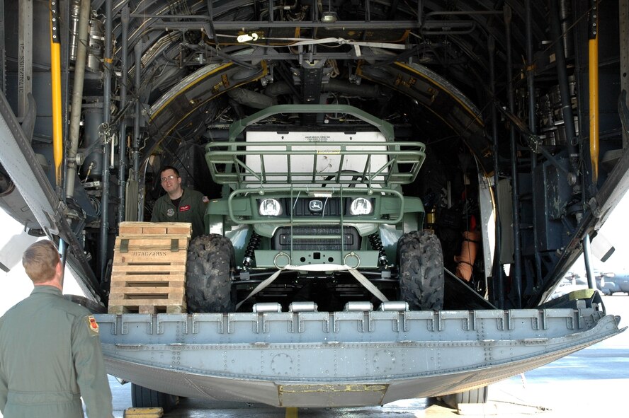 DYESS AIR FORCE BASE, Texas -- Staff Sgt. Henry Morgan, 317th Airlift Group, discusses the load aboard a C-130 Hercules with a fellow loadmaster Jan. 17 at an East Coast Air Force Base. The C-130 crew of six departed Dyess Air Force Base to support relief efforts following the 7.0-magnitude earthquake that devistated the Caribbean nation Jan. 14. The Air Force's airlift capability enables the United States to respond immediately to any disaster domestically or worldwide. We are the only country with an aircraft fleet capable of providing this type of response.