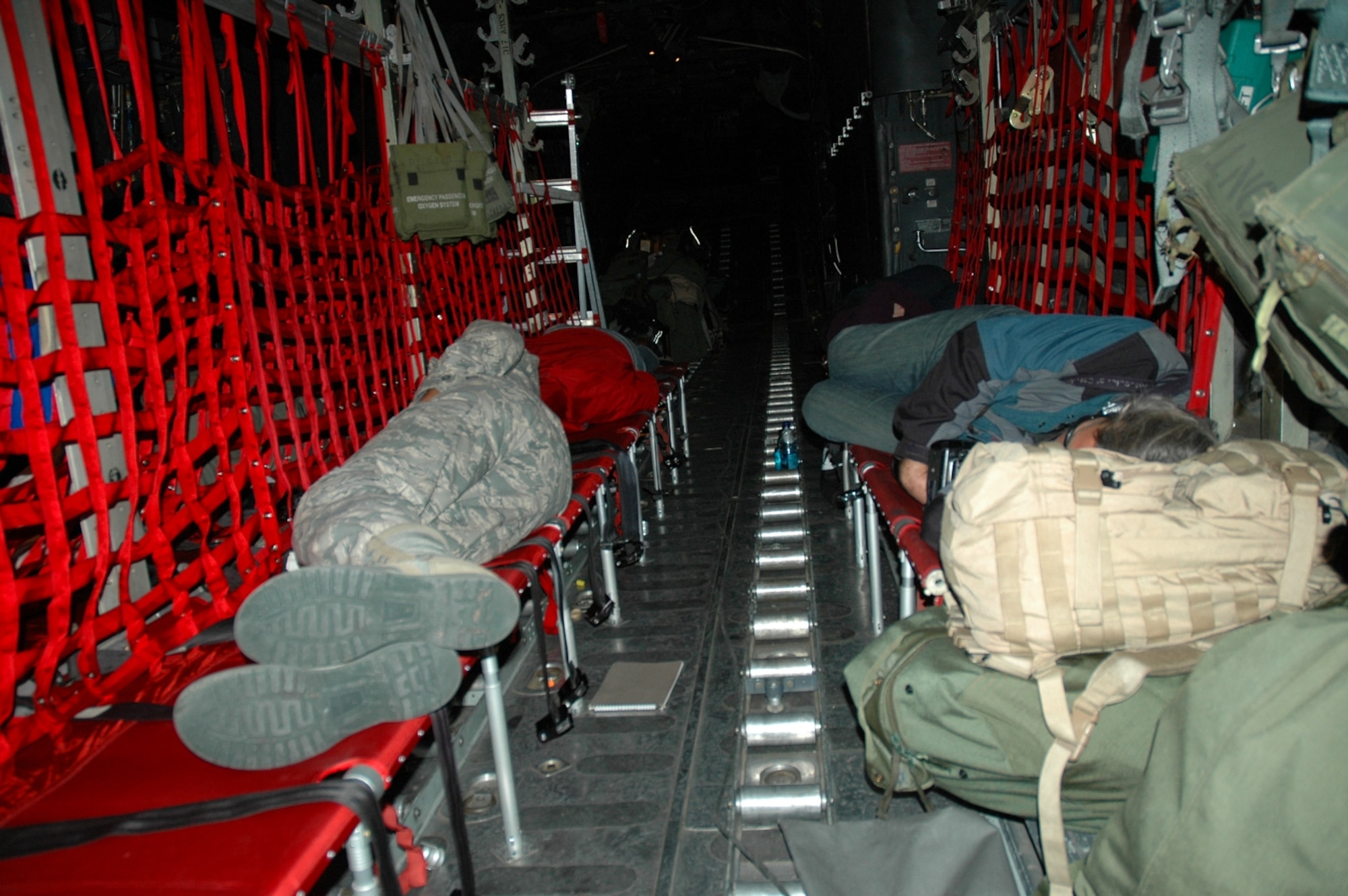 DYESS AIR FORCE BASE, Texas -- Dyess Public Affairs Specialist Airman 1st Class Robert Hicks (left front) and Abilene, Texas media catch sleep while they can aboard a 317th Airlift Group C-130 Hercules Jan. 16. The C-130 crew of six departed Dyess Air Force Base to support relief efforts following the 7.0-magnitude earthquake that devistated the Caribbean nation Jan. 14. The Air Force's airlift capability enables the United States to respond immediately to any disaster domestically or worldwide. We are the only country with an aircraft fleet capable of providing this type of response.
