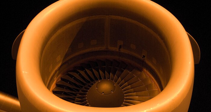 The jet engine of a McChord AFB C-17 awaits startup shortly before a mission to Haiti on the flightline at Charleston AFB Jan. 18. Members of the 437th Aerial Port Squadron and 10th Airlift Squadron loadmasters worked together to load 16 pallets of humanitarian aid, which weighed approximately 116,000 pounds and included more than 40,000 bottles of water and 30,000 meals. The supplies were flown out of Charleston AFB at approximately 6:30 a.m. on the first mission to leave the base since it assumed the role of a distribution hub for food and water to Haiti. (U.S. Air Force photo/Staff Sgt. Daniel Bowles)
