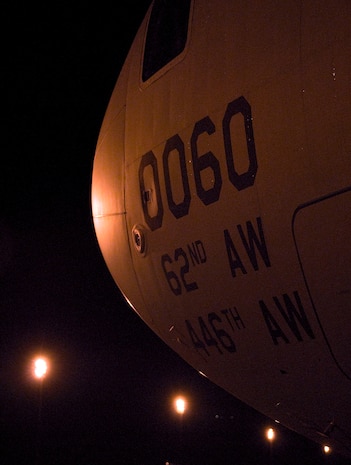 A McChord AFB C-17 waits on the flightline after being loaded with cargo at Charleston AFB Jan. 18. Members of the 437th Aerial Port Squadron and 10th Airlift Squadron loadmasters worked together to load 16 pallets of humanitarian aid, which weighed approximately 116,000 pounds and included more than 40,000 bottles of water and 30,000 meals. The supplies were flown out of Charleston AFB at approximately 6:30 a.m. on the first mission to leave the base since it assumed the role of a distribution hub for food and water to Haiti. (U.S. Air Force photo/Staff Sgt. Daniel Bowles)