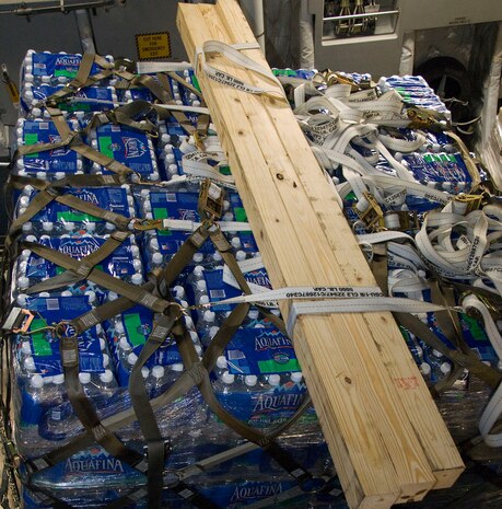 A pallet of bottled water sits on a McChord AFB C-17 after being loaded at Charleston AFB Jan. 18. Members of the 437th Aerial Port Squadron and 10th Airlift Squadron loadmasters worked together to load 16 pallets of food and water, which weighed approximately 116,000 pounds and included more than 40,000 bottles of water and 30,000 meals. The supplies were flown out of Charleston AFB at approximately 6:30 a.m. on the first mission to leave the base since it assumed the role of a distribution hub for food and water to Haiti. (U.S. Air Force photo/Staff Sgt. Daniel Bowles)