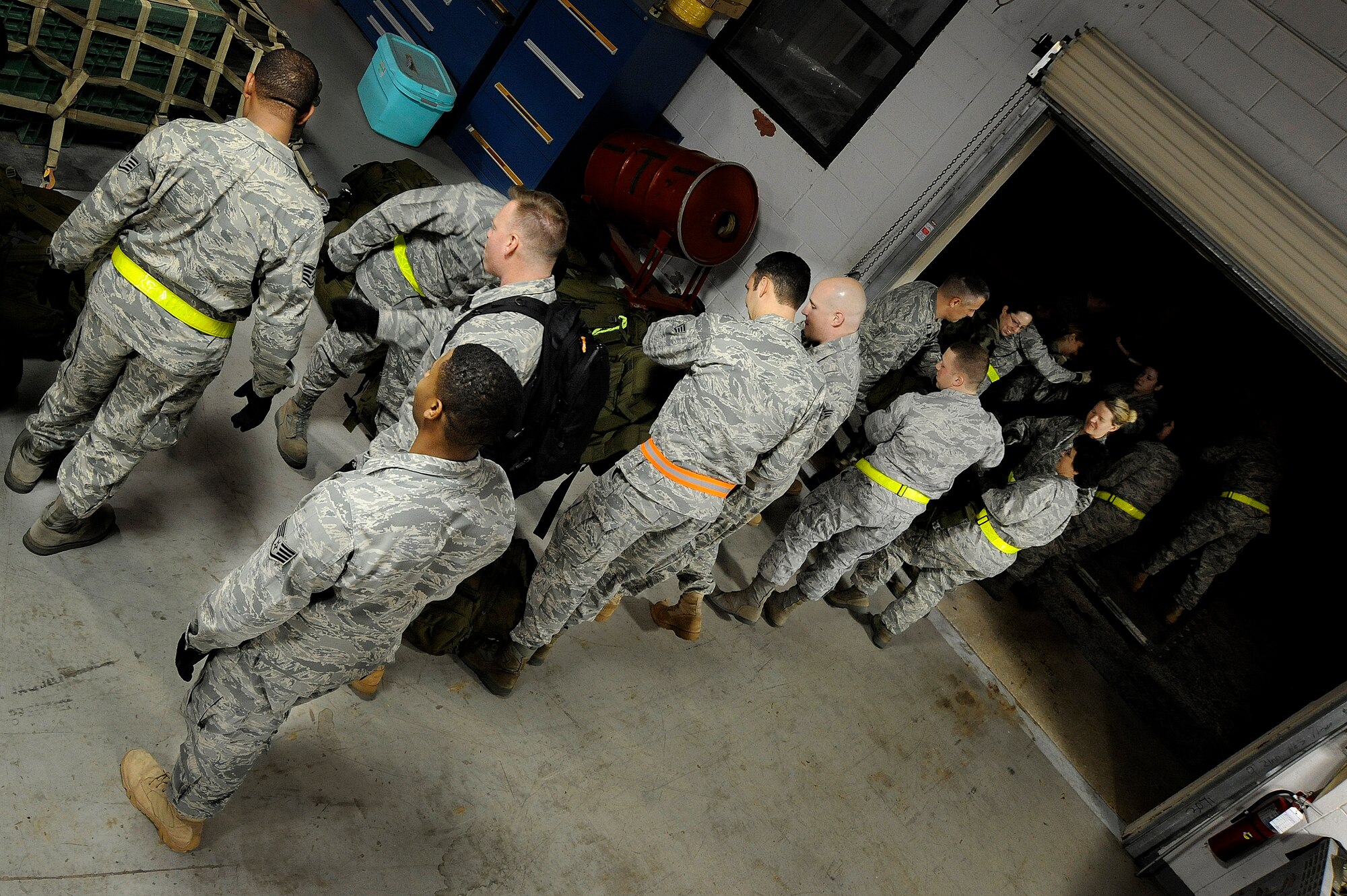 Members of the 6th Medical Group Mobile Aromedical Staging Facility team form a line to build a pallet for their bags at MacDill Air Force Base Jan. 18. The MASF team was headed to Haiti to provide medical aide to the victims of last weeks earthquake.
(U.S. Air Force photo by Staff Sgt. Joseph Swafford) 
