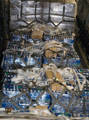 Pallets of bottled water sit on a McChord AFB C-17 after being loaded at Charleston AFB Jan. 18. Members of the 437th Aerial Port Squadron and 10th Airlift Squadron loadmasters worked together to load 16 pallets of food and water, which weighed approximately 116,000 pounds and included more than 40,000 bottles of water and 30,000 meals. The supplies were flown out of Charleston AFB at approximately 6:30 a.m. on the first mission to leave the base since it assumed the role of a distribution hub for food and water to Haiti. (U.S. Air Force photo/Staff Sgt. Daniel Bowles)