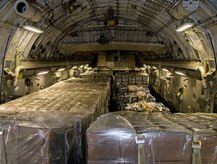 Nine pallets of bottled water and seven pallets of Meals-Ready-to-Eat sit on a McChord AFB C-17 after being loaded at Charleston AFB Jan. 18. Members of the 437th Aerial Port Squadron and 10th Airlift Squadron loadmasters worked together to load the 16 pallets, which weighed approximately 116,000 pounds and included more than 40,000 bottles of water and 30,000 meals. The supplies were flown out of Charleston AFB at approximately 6:30 a.m. on the first mission to leave the base since it assumed the role of a distribution hub for food and water to Haiti. (U.S. Air Force photo/Staff Sgt. Daniel Bowles)