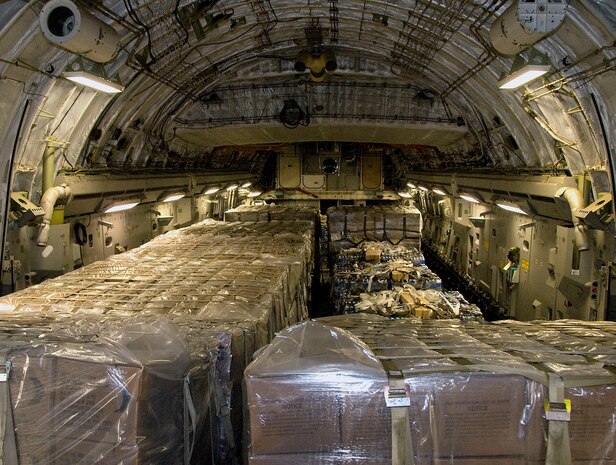 Nine pallets of bottled water and seven pallets of Meals-Ready-to-Eat sit on a McChord AFB C-17 after being loaded at Charleston AFB Jan. 18. Members of the 437th Aerial Port Squadron and 10th Airlift Squadron loadmasters worked together to load the 16 pallets, which weighed approximately 116,000 pounds and included more than 40,000 bottles of water and 30,000 meals. The supplies were flown out of Charleston AFB at approximately 6:30 a.m. on the first mission to leave the base since it assumed the role of a distribution hub for food and water to Haiti. (U.S. Air Force photo/Staff Sgt. Daniel Bowles)
