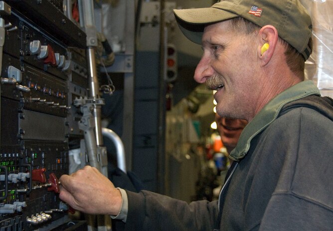Lawrence Curtis uses a control panel from the rear of a McChord C-17 on the Charleston AFB flightline Jan. 18 to close the loading ramp after the last of 16 pallets were loaded. The loading ramp of the C-17 can be positioned in the full-down position to allow vehicles to be driven onboard, or positioned halfway to loading of cargo pallets. Mr. Curtis is a work leader with the 437th Aerial Port Squadron ramp services section. (U.S. Air Force photo/Staff Sgt. Daniel Bowles)
