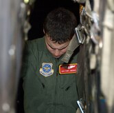 Senior Airman Anthony Jimenez eyes the alignment of pallets aboard a McChord C-17 on the Charleston AFB flightline Jan. 18. Sixteen pallets of food and water were loaded during the first of many missions to be flown out of Charleston AFB to aid victims of the recent earthquake in Haiti. Airman Jimenez is a loadmaster with the 10th Airlift Squadron, McChord AFB, Wash. (U.S. Air Force photo/Staff Sgt. Daniel Bowles)