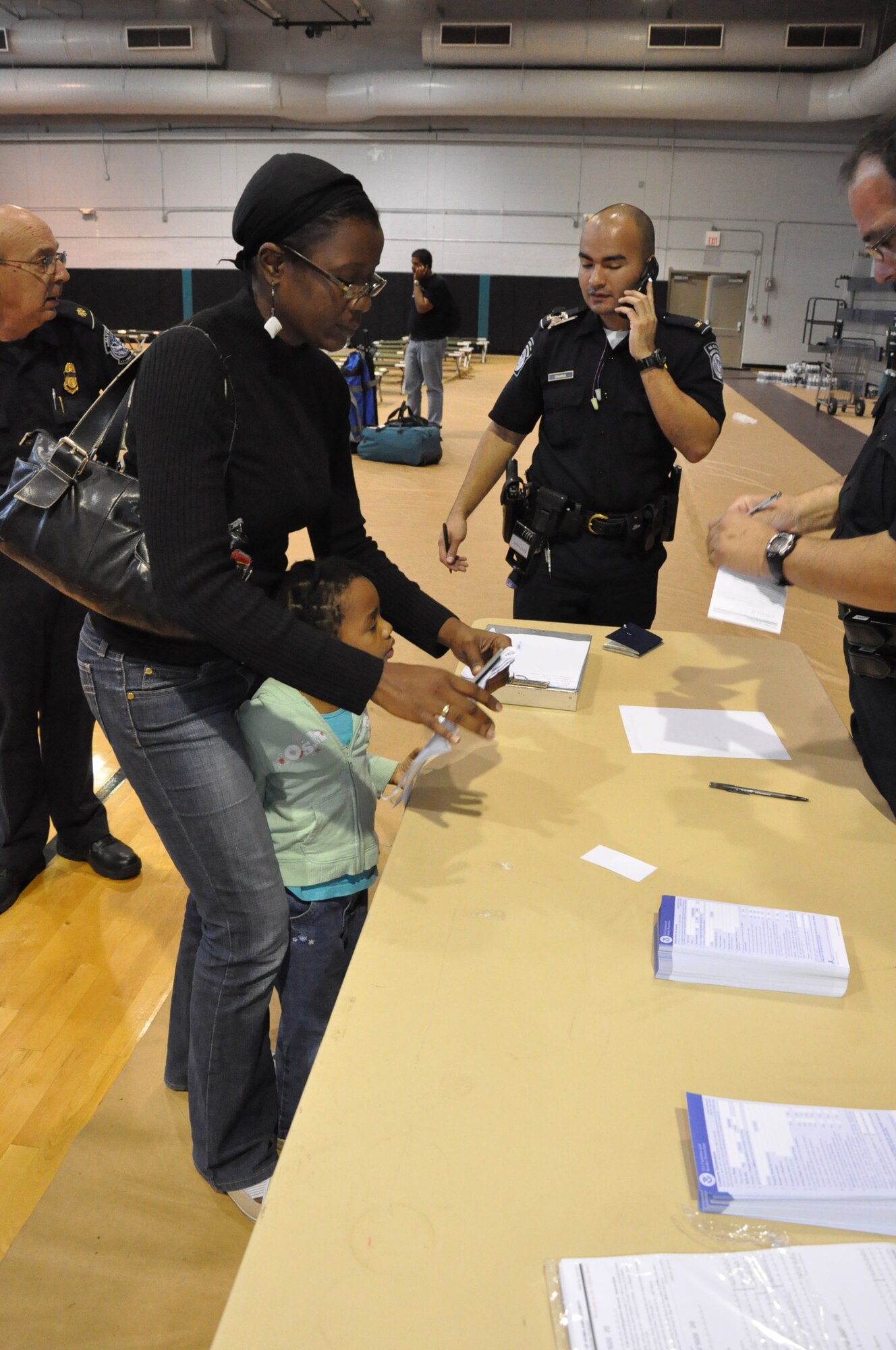 U.S. Customs and Border Patrol were on hand at the Homestead air Reserve Base to help process American citizens back to the United States from Haiti, Fri. Jan. 15, 2010. Citizens were checked through customs at the base gym. (U.S. Air Force photo/Tech. Sgt. Robert D. Gibson)