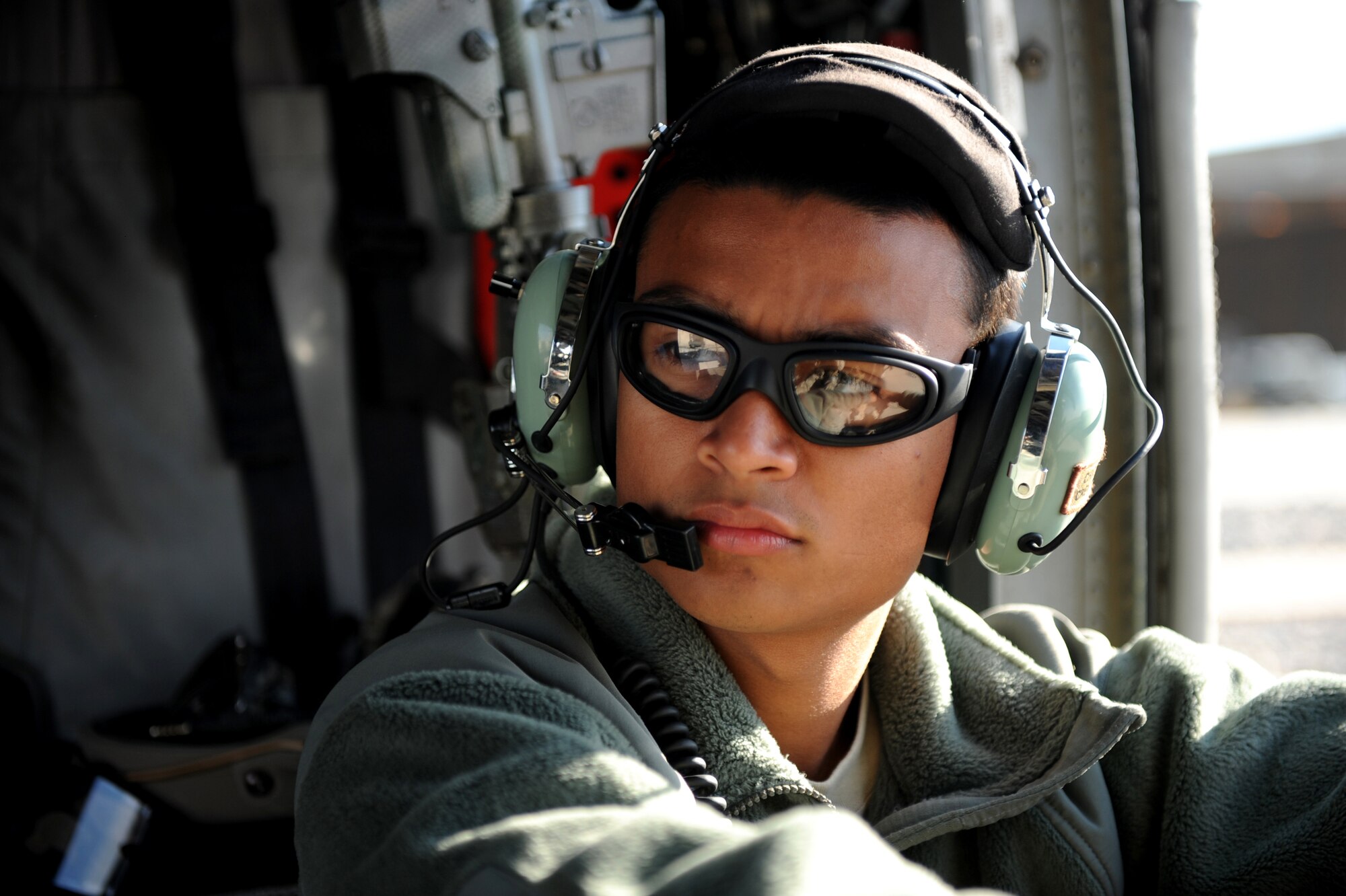 U.S. Air Force Senior Airman Harvey Gonzales, a crew chief with the 66th Expeditionary Rescue Squadron, waits onboard a HH-60G Pave Hawk prior to a medical evacuation mission, Jan. 10, 2010, at Kandahar Airfield, Afghanistan. (U.S. Air Force photo/Staff Sgt. Manuel J. Martinez/Released)
