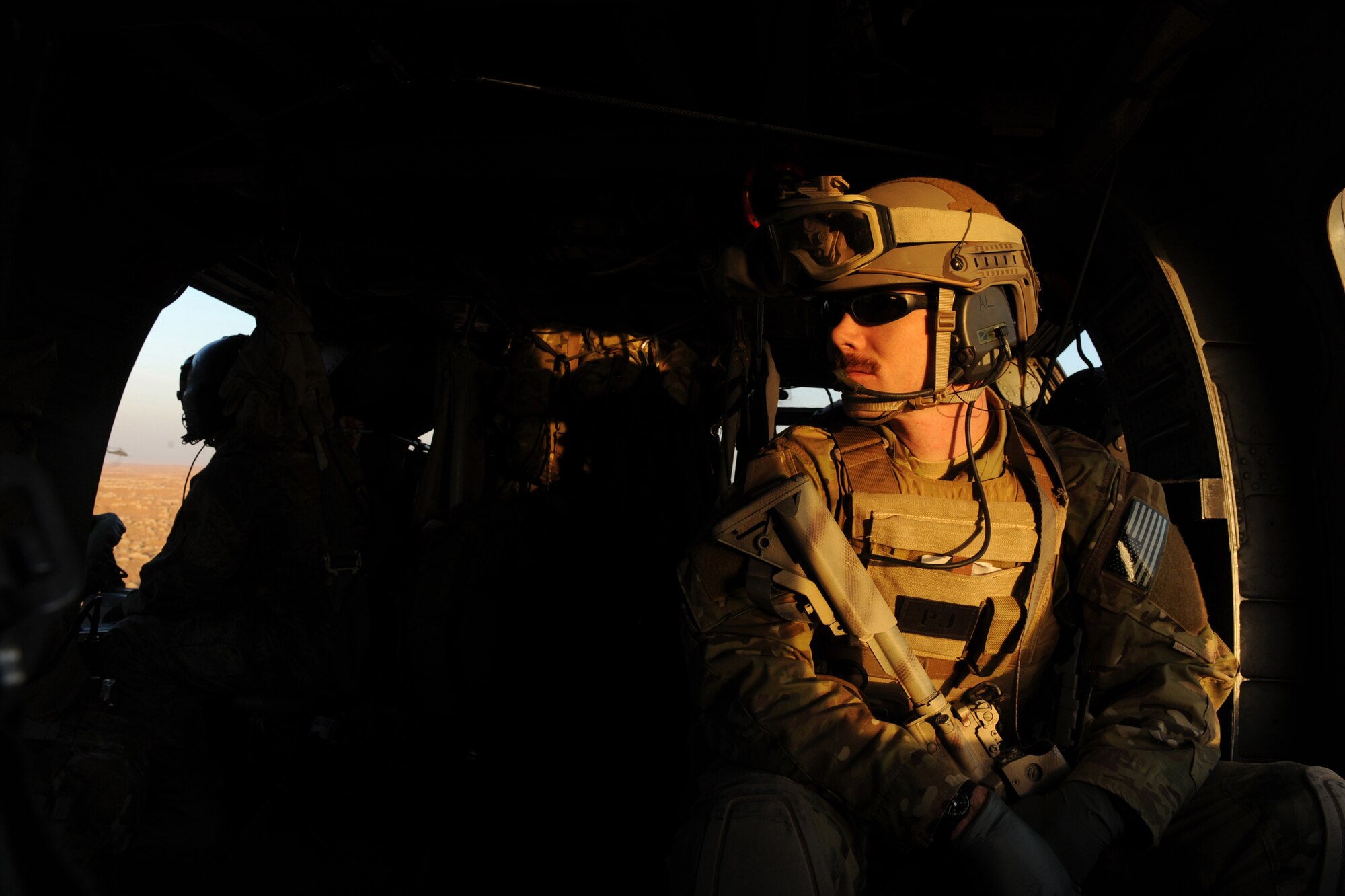 U.S. Air Force Staff Sgt. Demian Abel, a pararescue jumper with the 66th Expeditionary Rescue Squadron, scans the horizon for potential threats to his HH-60G Pave Hawk crew during a medical evacuation (MEDEVAC) mission, Jan. 10, 2010, over Kandahar Province, Afghanistan. (U.S. Air Force photo/Staff Sgt. Manuel J. Martinez/Released)
