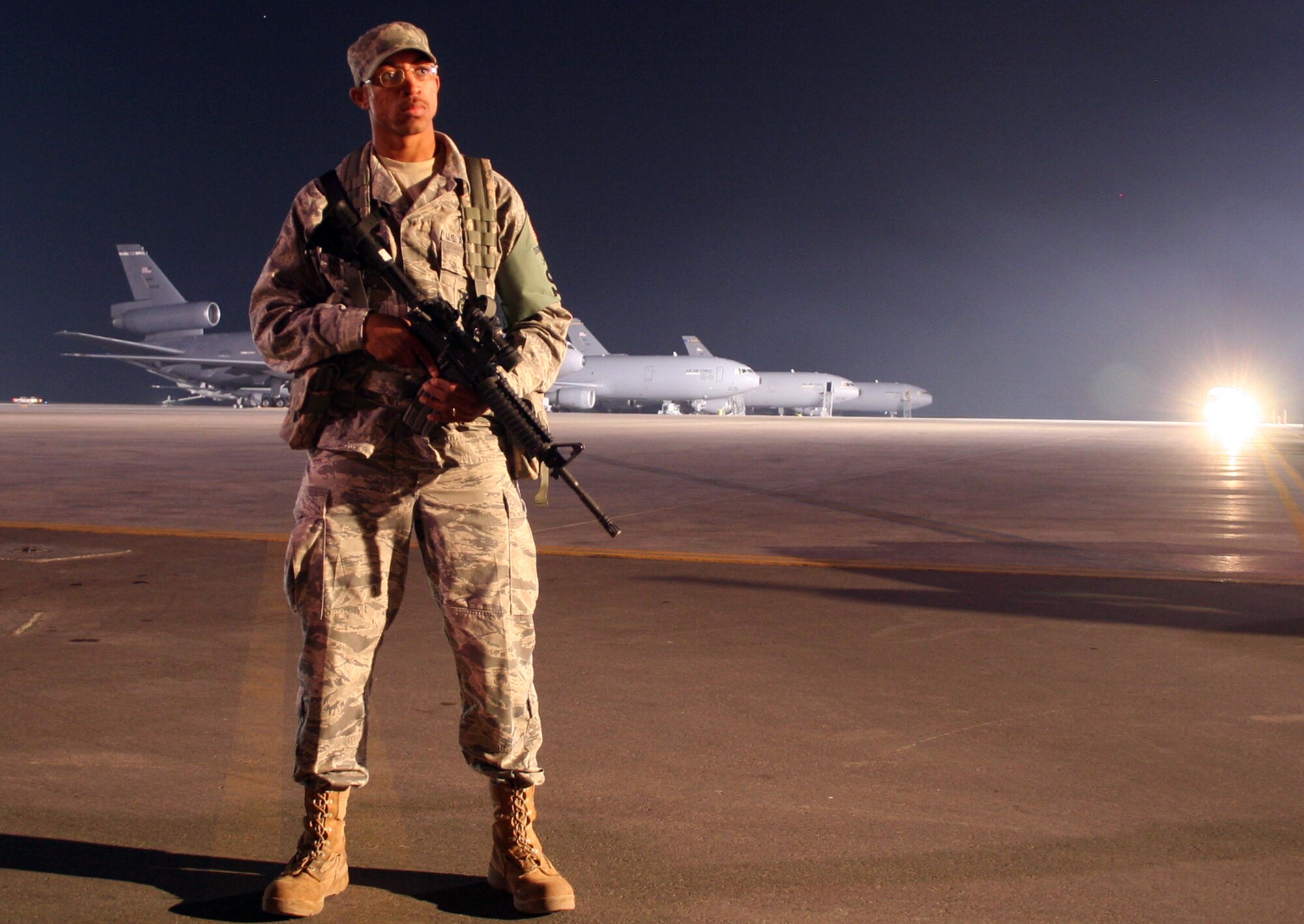 Staff Sgt. LeTari Myles, security forces response team leader with the 380th Expeditionary Security Forces Squadron, watches over the flightline in the early morning hours at a non-disclosed base in Southwest Asia on Jan. 18, 2010.  Sergeant Myles and his fellow security forces Airmen from the 380th ESFS are responsible for keeping nearly 1,900 people safe along with protecting millions of dollars of equipment, aircraft and assets.  Sergeant Myles is deployed from the 43rd Security Forces Squadron at Pope Air Force Base, N.C., and his hometown is Detroit, Mich. (U.S. Air Force Photo/Tech. Sgt. Scott T. Sturkol/Released)