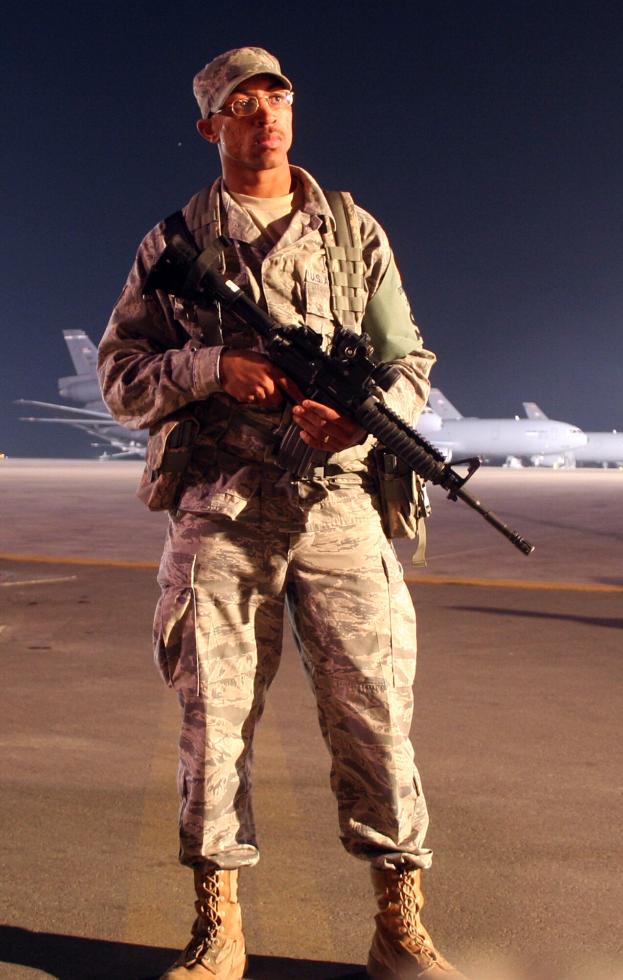 Staff Sgt. LeTari Myles, security forces response team leader with the 380th Expeditionary Security Forces Squadron, watches over the flightline in the early morning hours at a non-disclosed base in Southwest Asia on Jan. 18, 2010.  Sergeant Myles and his fellow security forces Airmen from the 380th ESFS are responsible for keeping nearly 1,900 people safe along with protecting millions of dollars of equipment, aircraft and assets.  Sergeant Myles is deployed from the 43rd Security Forces Squadron at Pope Air Force Base, N.C., and his hometown is Detroit, Mich. (U.S. Air Force Photo/Tech. Sgt. Scott T. Sturkol/Released)