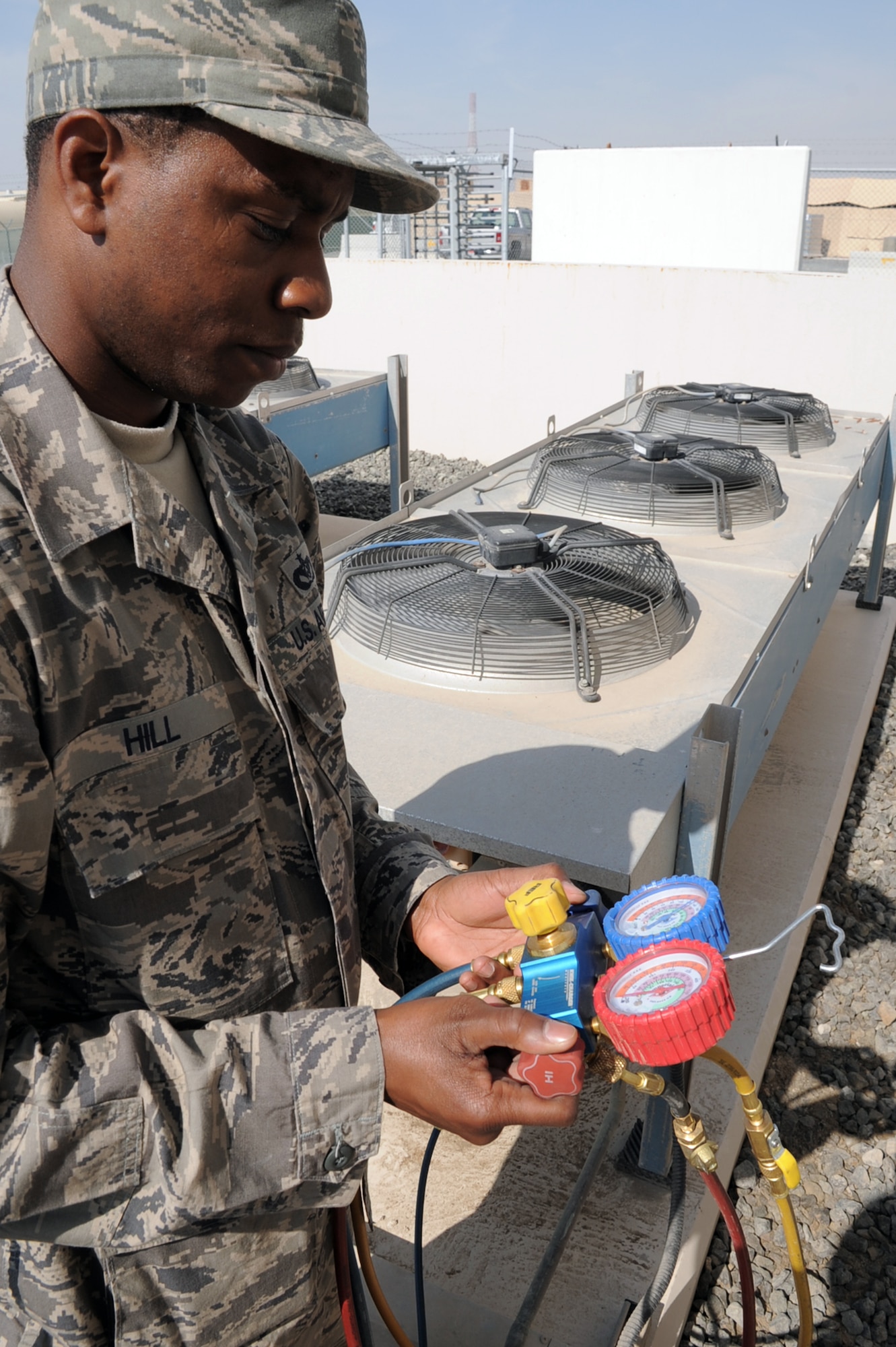 Tech. Sgt. Roderick Hill, heating, ventilation and air conditioning craftsman with the 380th Expeditionary Civil Engineer Squadron, chacks an air conditioning unit during operations at a non-disclosed base in Southwest Asia on Jan. 17, 2010. A 12-year veteran of the Air Force, Sergeant Hill is reponsible for maintaining HVAC equipment throughout the 380th Air Expeditionary Wing.  Sergeant Hill is deployed from the 786th Civil Engineer Squadron at Ramstein Air Base, Germany, and his hometown is Moreauville, La. (U.S. Air Force Photo/Tech. Sgt. Scott T. Sturkol/Released)