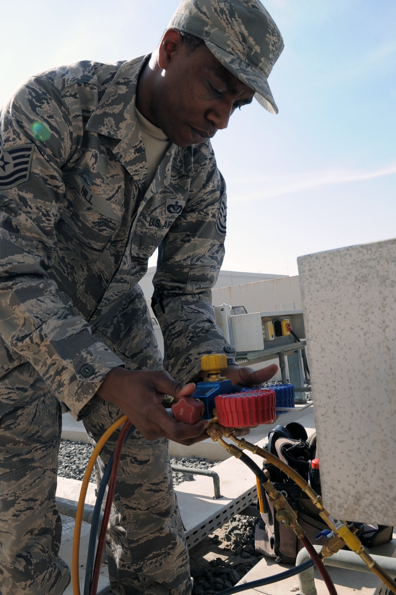 Tech. Sgt. Roderick Hill, heating, ventilation and air conditioning craftsman with the 380th Expeditionary Civil Engineer Squadron, chacks an air conditioning unit during operations at a non-disclosed base in Southwest Asia on Jan. 17, 2010. A 12-year veteran of the Air Force, Sergeant Hill is reponsible for maintaining HVAC equipment throughout the 380th Air Expeditionary Wing.  Sergeant Hill is deployed from the 786th Civil Engineer Squadron at Ramstein Air Base, Germany, and his hometown is Moreauville, La. (U.S. Air Force Photo/Tech. Sgt. Scott T. Sturkol/Released)