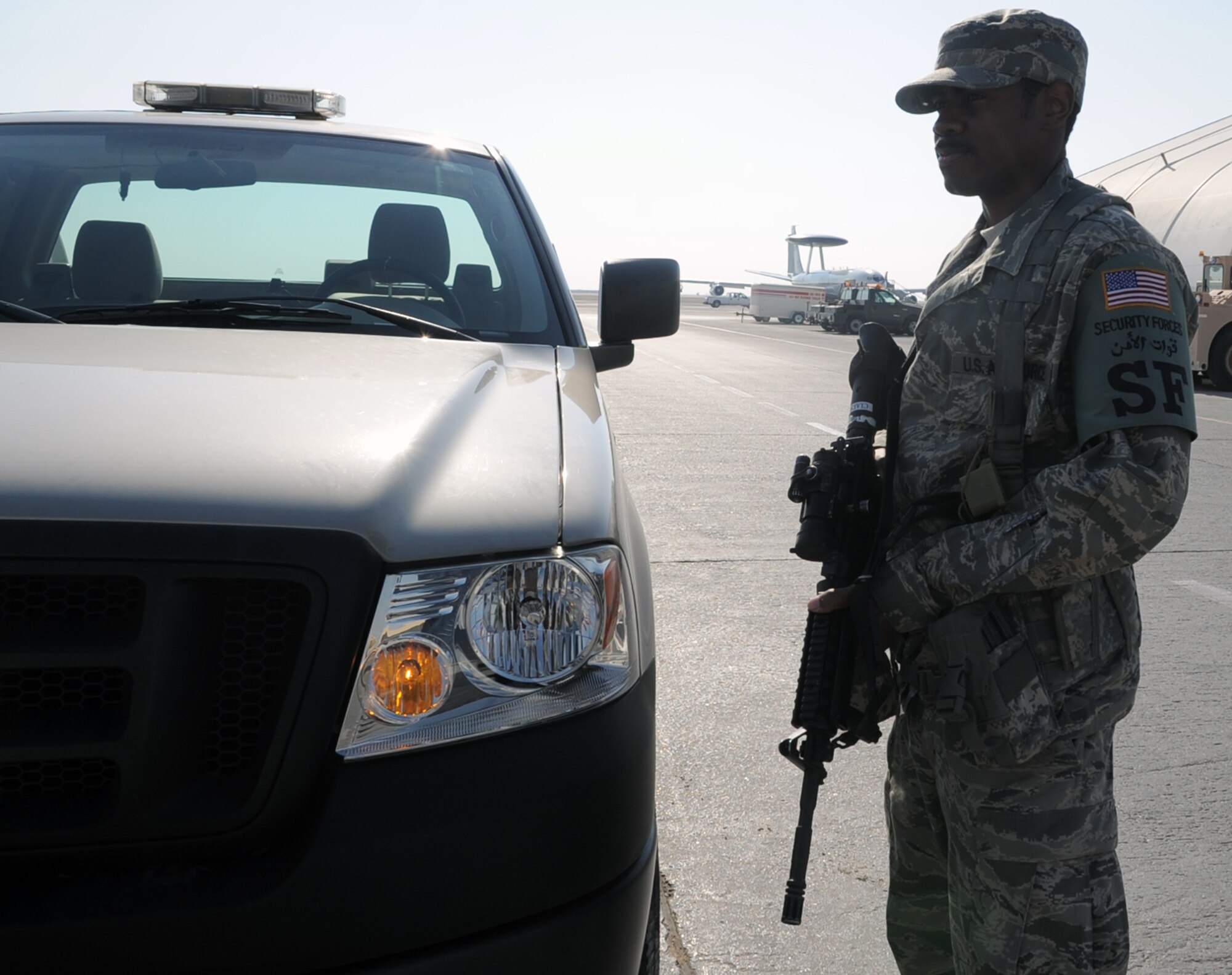 Senior Airman George Clark, security forces journeyman with the 380th Expeditionary Security Forces Squadron, watches over the flightline at a non-disclosed location in Southwest Asia.  Air Force security forces Airmen like Airman Fitzgerald ensure the security of the 380th Air Expeditionary Wing areas of operation and protect millions of dollars worth of assets.  Airman Fitzgerald is deployed from the 81st Security Forces Squadron at Keesler Air Force Base, Miss., and his hometown is Lecompte, La.  (U.S. Air Force Photo/Tech. Sgt. Scott T. Sturkol/Released)