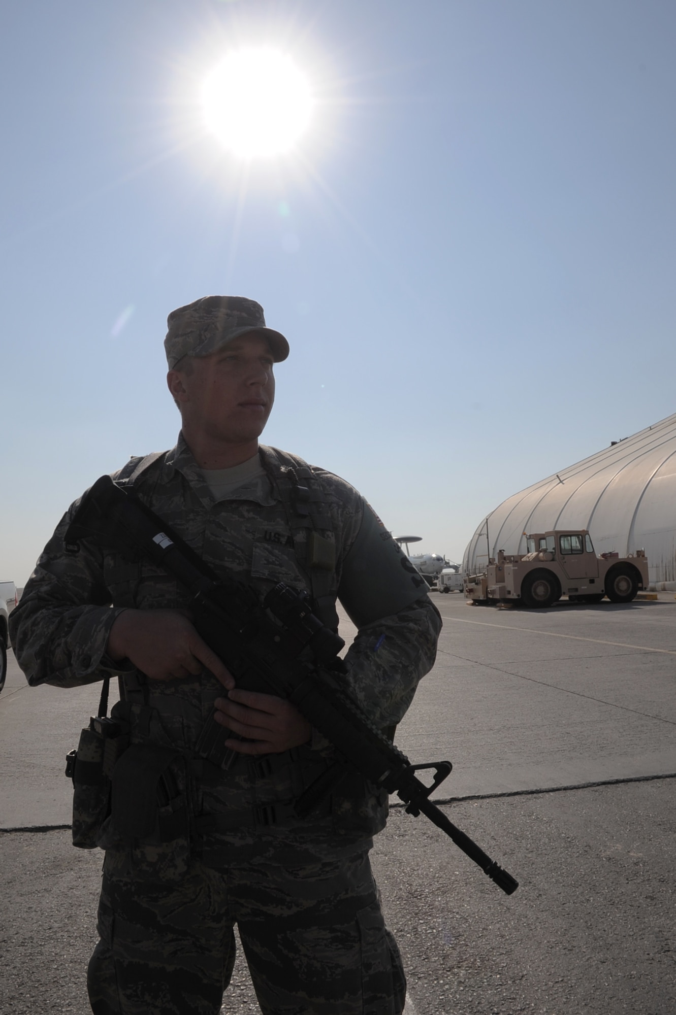 Senior Airman Jeffery Fitzgerald, security forces journeyman with the 380th Expeditionary Security Forces Squadron, watches over the flightline at a non-disclosed location in Southwest Asia.  Air Force security forces Airmen like Airman Fitzgerald ensure the security of the 380th Air Expeditionary Wing areas of operation and protect millions of dollars worth of assets.  Airman Fitzgerald is deployed from the 81st Security Forces Squadron at Keesler Air Force Base, Miss., and his hometown is Smiths Station, Ala.  (U.S. Air Force Photo/Tech. Sgt. Scott T. Sturkol/Released)