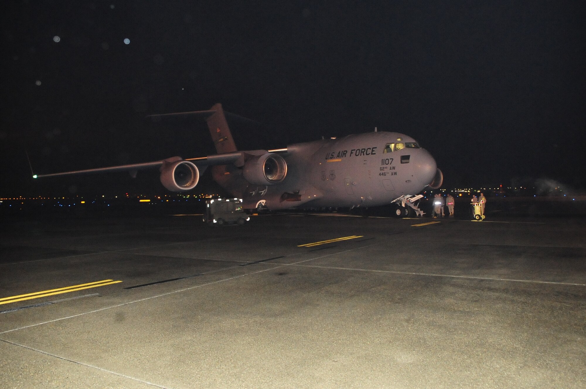 Airmen prepare a C-17 Globemaster III for departure from McChord in support of ongoing humanitarian relief efforts in Haiti. Two additional C-17s were dispatched Sunday to Pope AFB, N.C. and Charleston AFB, S.C., respectively, to pick up critical supplies and deliver them to Haiti; a fourth C-17 departed Jan. 18 for Pope.  The Charleston-bound aircraft carried two additional augmented aircrews to be assigned to other C-17s supporting the relief effort from Charleston.  All aircraft departed Haiti with evacuees. (Courtesy photo)