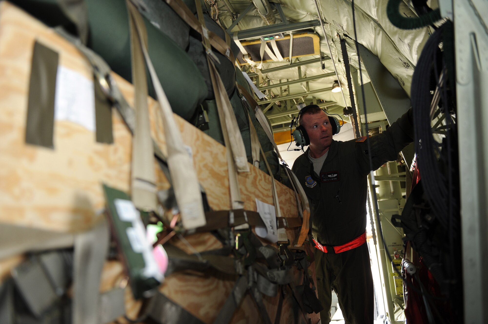 U.S. Air Force Tech. Sgt. Charles Moore, a loadmaster from the 41st Airlift Squadron, Little Rock Air Force Base, Ark., engages the floor locks to secure a cargo pallet from moving aboard a C-130J Hercules aircraft at Pope Air Force Base, S.C., on Jan.16, 2009.  The C-130J aircraft will be transporting the Soldiers and various supplies to assist in Haitian relief efforts after a devastating earthquake struck the country Jan. 12, 2010. Little Rock AFB is a component of Air Mobility Command. Since relief operations began Jan. 13, 2010, AMC aircraft have deliver more than 323 tons of emergency tons of cargo to Haiti. (USAF Photo by Staff Sgt. Chad Chisholm) (RELEASED)

