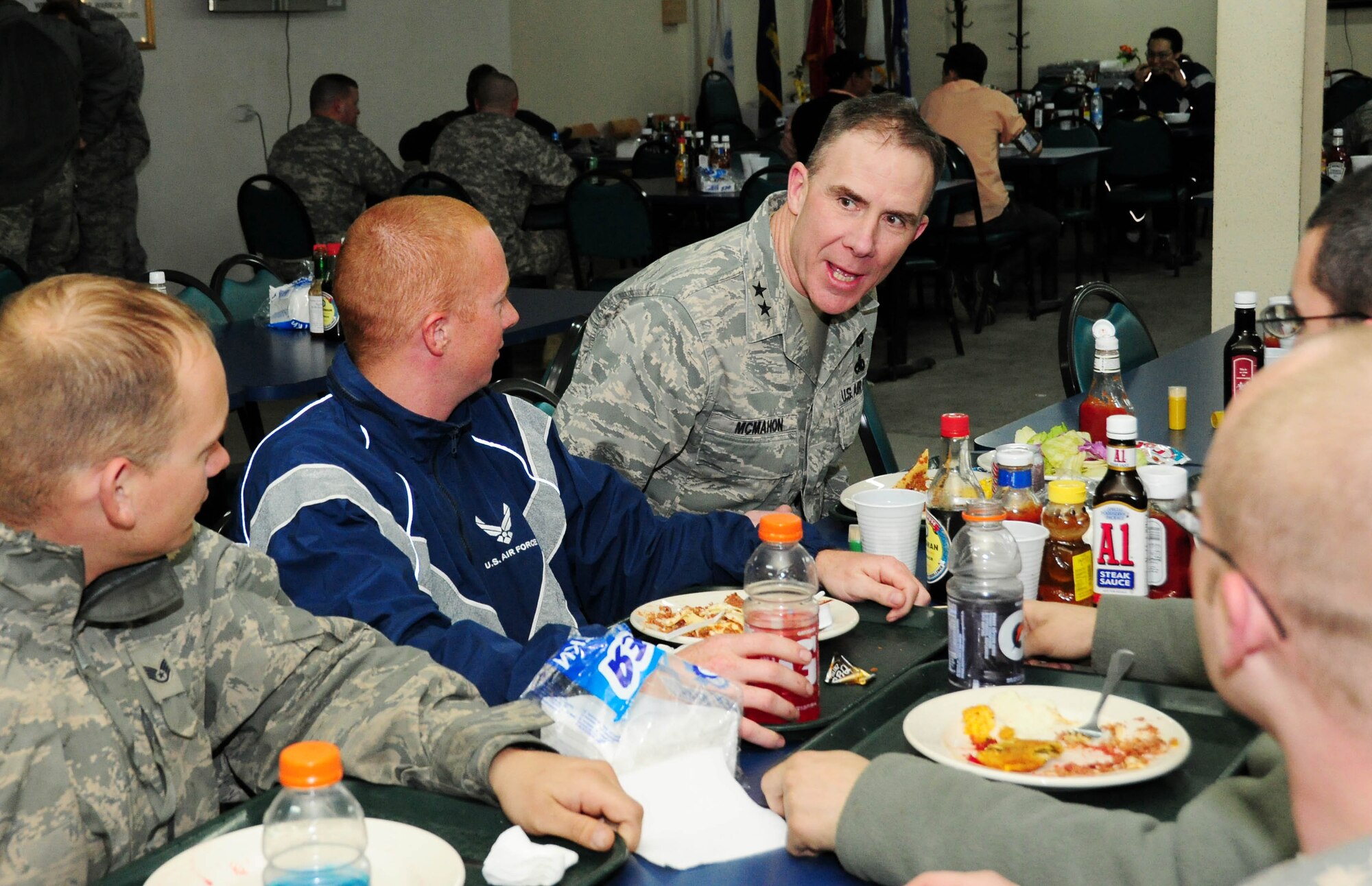 TRANSIT CENTER AT MANAS, Kyrgyzstan - Maj. Gen. Robert H. McMahon, Director of Logistics, Deputy Chief of Staff for Logistics, Installations and Mission Support, Headquarters U.S. Air Force, Washington, D.C., speaks with Airmen over dinner here Jan. 16. The maintenance Airmen are transiting home from Kandahar, Afghanistan and are from the 355th Aircraft Maintenance Squadron, Davis-Monthan Air Force Base, Ariz. (U.S. Air Force photo by Senior Airman Nichelle Anderson)