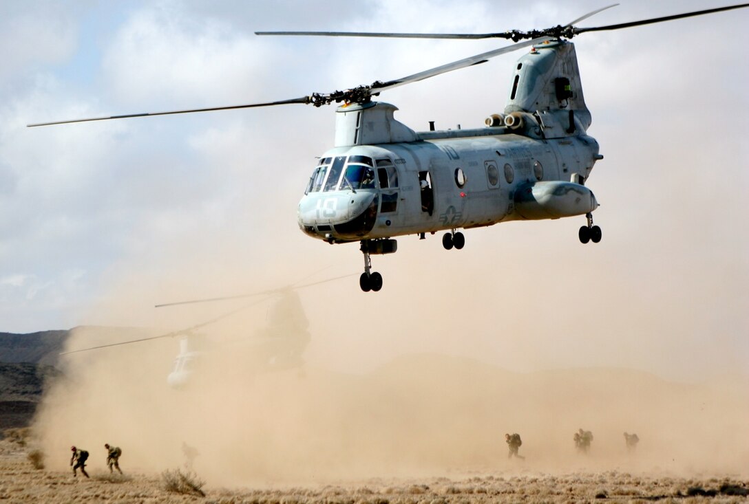 US Marine CH-46 Sea Knight helicopters from the 11th Marine Expeditionary Unit's air combat element, Marine Medium Helicopter Squadron 166 (Reinforced), depart a landing zone after inserting French soldiers here Jan. 16. The air insert was the first stage of the soldiers 10-day desert survival training exercise.::r::::n::