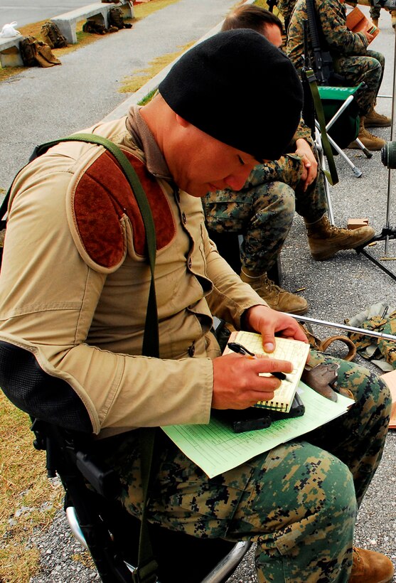 1st Lt. Enming Luo, executive officer for Headquarters and Service Battalion, 3rd Marine Division, III Marine Expeditionary Force, keeps track of his fellow Marines' scores during the Far East Division Matches on Camp Hansen Jan. 19.