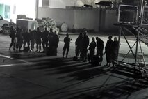 PORT-AU-PRINCE INTERNATIONAL AIRPORT, Haiti -- A group of U.S. Military medical personnel stand on the tarmac outside of hangar here after arriving via a C-130H Hercules tactical cargo transport aircraft assigned to Air Force Reserve Command's 910th Airlift Wing, January 18.  The medical personnel, consisting of U.S. Army and Air Force Servicemembers were flown, by the 910th's C-130, to Haiti from Soto Cano Air Base, Honduras. The 910th, based at Youngstown Air Reserve Station, Ohio, has three aircraft and crews supporting the relief effort in the aftermath of a major earthquake that devastated Port-au-Prince and the surrounding areas. Currently more than 30 personnel from the 910th are flying relief effort missions with a myriad of Citizen Airmen working at YARS to provide home station support to the crews. The 910th Airlift Wing stands ready to provide airlift capabilities to the massive humanitarian effort as long as needed by mission requirements. 