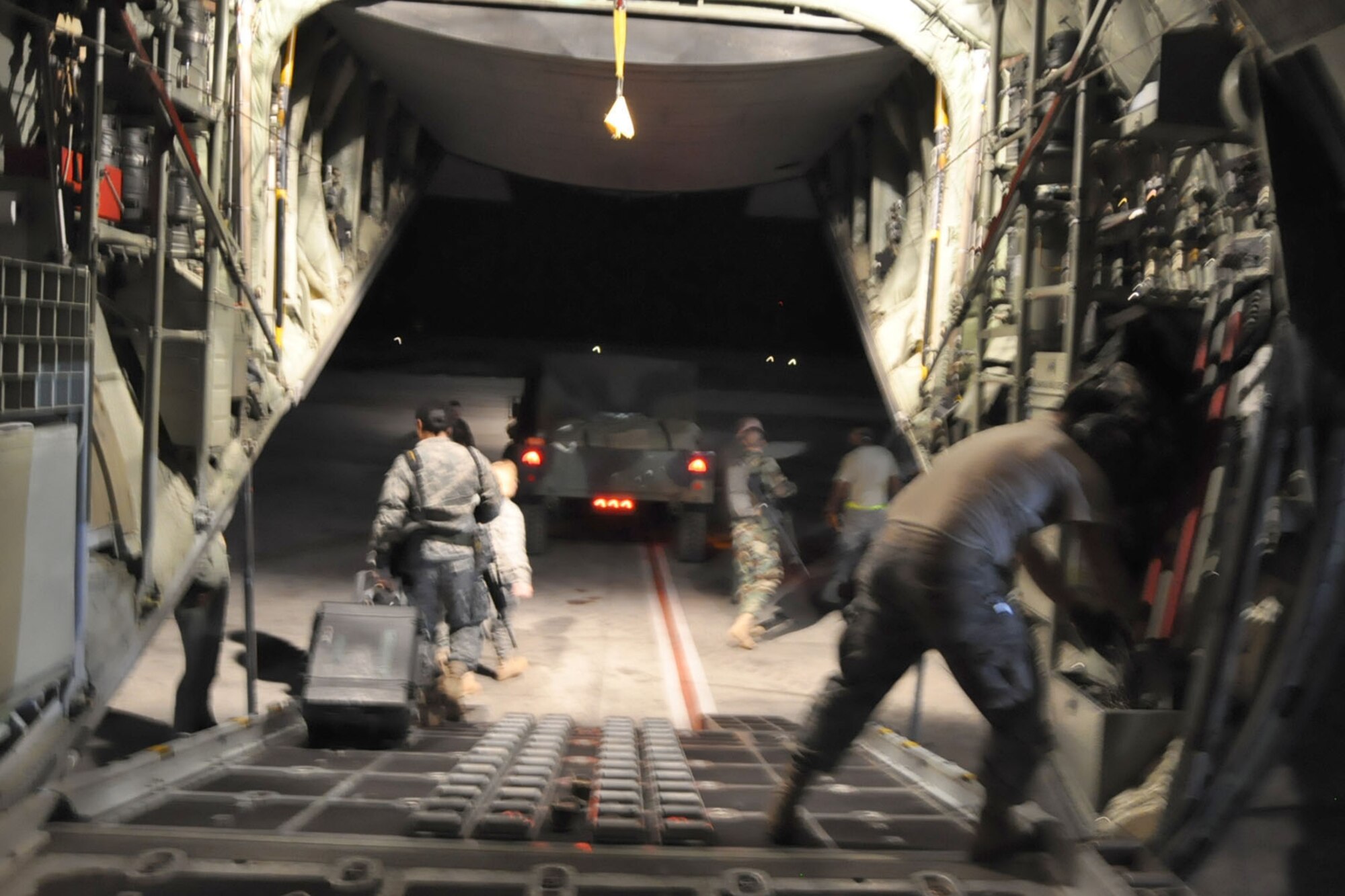PORT-AU-PRINCE INTERNATIONAL AIRPORT, Haiti -- The last member of a group of 19 U.S. Military medical personnel walks down the rear cargo ramp of a C-130H Hercules tactical cargo transport aircraft, assigned to Air Force Reserve Command's 910th Airlift Wing, on the tarmac here, January 18.  The medical personnel, consisting of U.S. Army and Air Force Servicemembers were flown, by the 910th's C-130, to Haiti from Soto Cano Air Base, Honduras. The 910th, based at Youngstown Air Reserve Station, Ohio, has three aircraft and crews supporting the relief effort in the aftermath of a major earthquake that devastated Port-au-Prince and the surrounding areas. Currently more than 30 personnel from the 910th are flying relief effort missions with a myriad of Citizen Airmen working at YARS to provide home station support to the crews. The 910th Airlift Wing stands ready to provide airlift capabilities to the massive humanitarian effort as long as needed by mission requirements.
