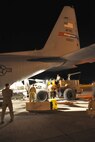 SOTO CANO AIR BASE, Honduras -- Air Force Reserve Maj. Joe George, assigned to the 910th Operations Support Squadron, observes as ground cargo handling personnel use a forklift to load a pallet load aboard a C-130H Hercules tactical cargo transport aircraft, assigned to the 910th Airlift Wing, on the cargo ramp here, January 17. Maj. George is pilot of the C-130H and commander of a 12-person crew from the 910th, based at Youngstown Air Reserve Station, Ohio, scheduled to deliver the pallet, a HUMVEE military vehicle, a trailer and supplies along with a group of U.S. Military medical personnel to Port-au-Prince International Airport, Haiti as part of the relief effort to aid the people of the stricken island nation in the aftermath of the massive earthquake that devastated Port-au-Prince and surrounding areas last week. The 910th currently has three aircraft, crews of more than 30 personnel flying relief effort missions and a myriad of Citizen Airmen working at YARS to provide home station support to the crews. The 910th Airlift Wing stands ready to provide airlift capabilities to the massive humanitarian effort as long as needed by mission requirements. 