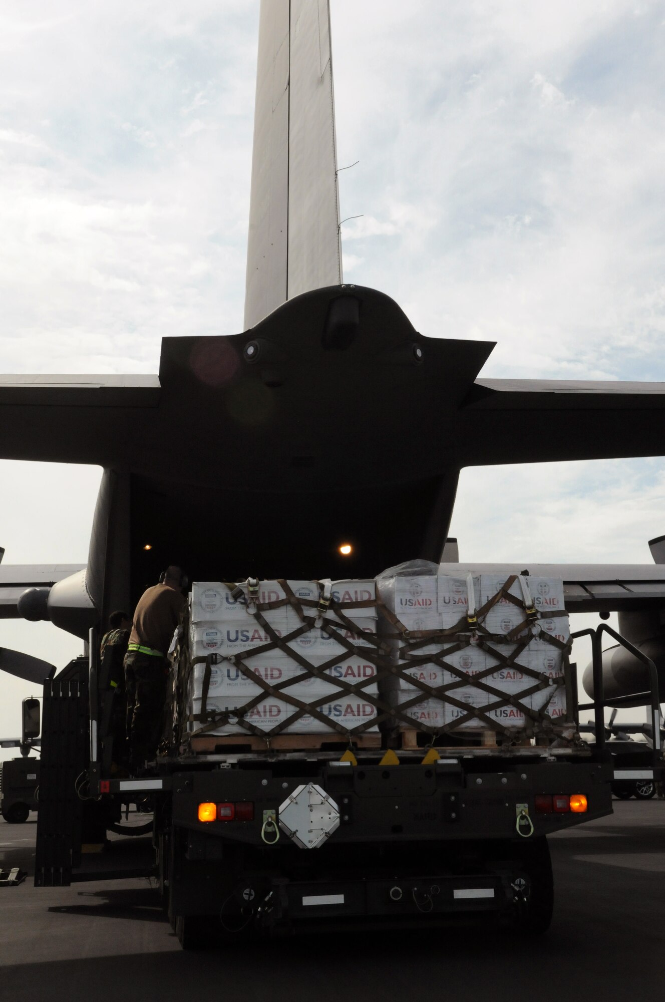 Airmen from the 42nd Aerial Porter Squadron load USAID packages, water, ready-to-eat meals and air conditioning units aboard a C-130 to Haiti to assist with Operation Unified Response, Jan. 18. (U.S. Air Force photo by Master Sgt. Sabrina Johnson) 